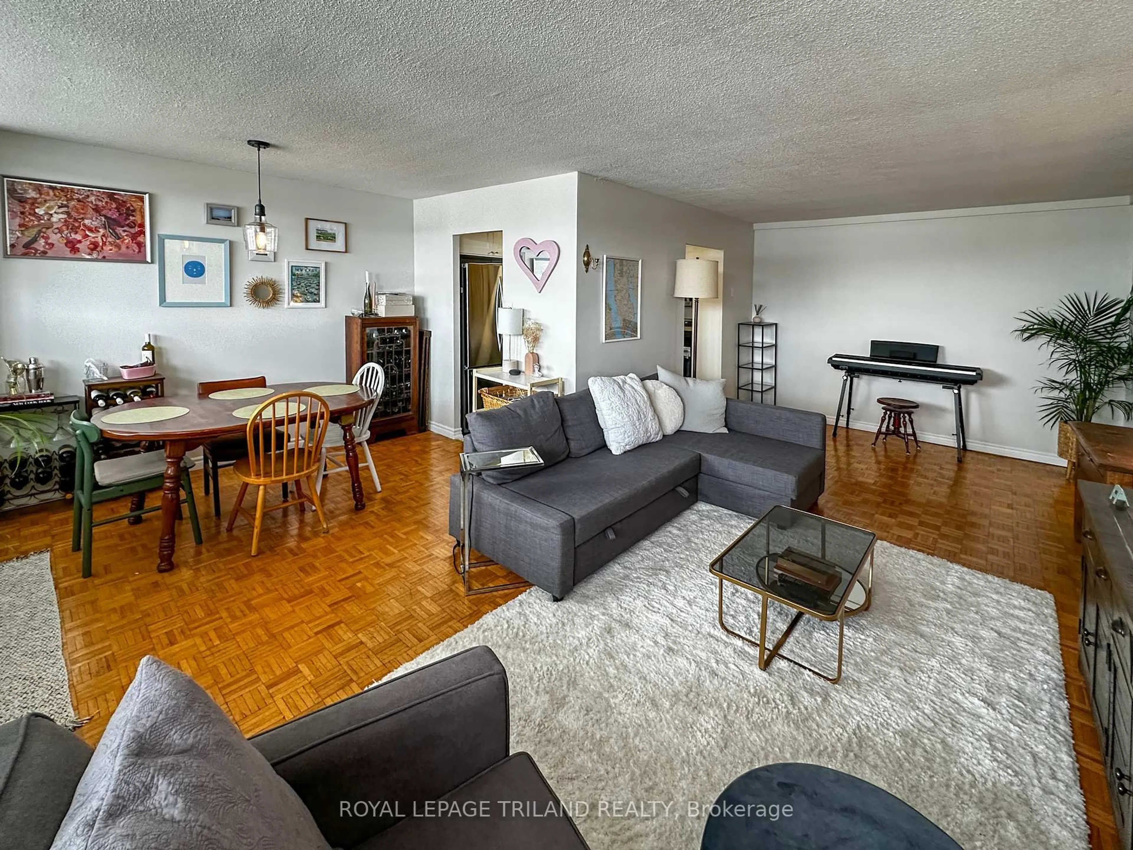 Living room with furniture, wood/laminate floor for 215 Glenridge Ave #901, St. Catharines Ontario L2T 3J7