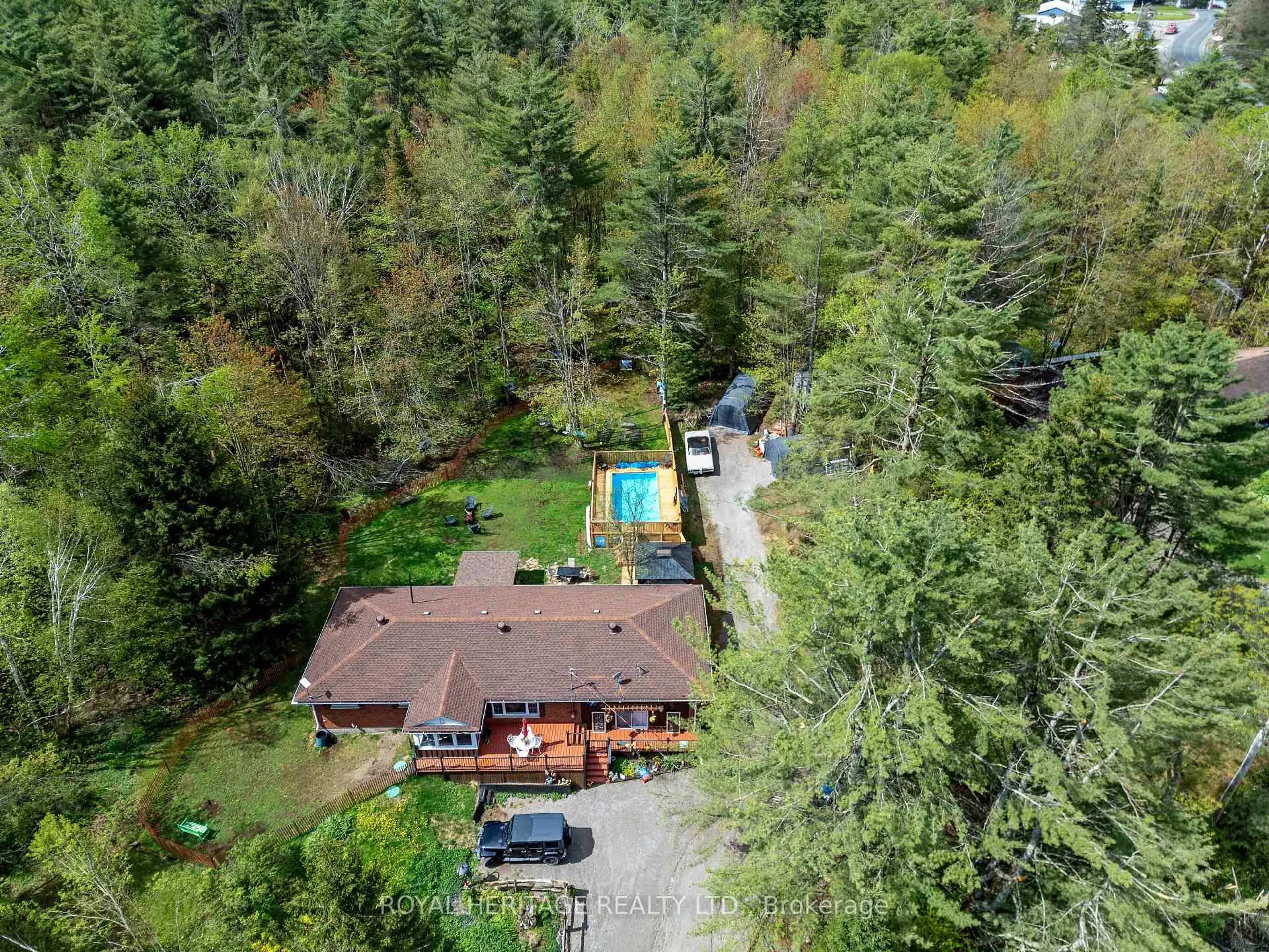 A pic from outside/outdoor area/front of a property/back of a property/a pic from drone, forest/trees view for 26 Reid St, Trent Lakes Ontario K0M 2A0