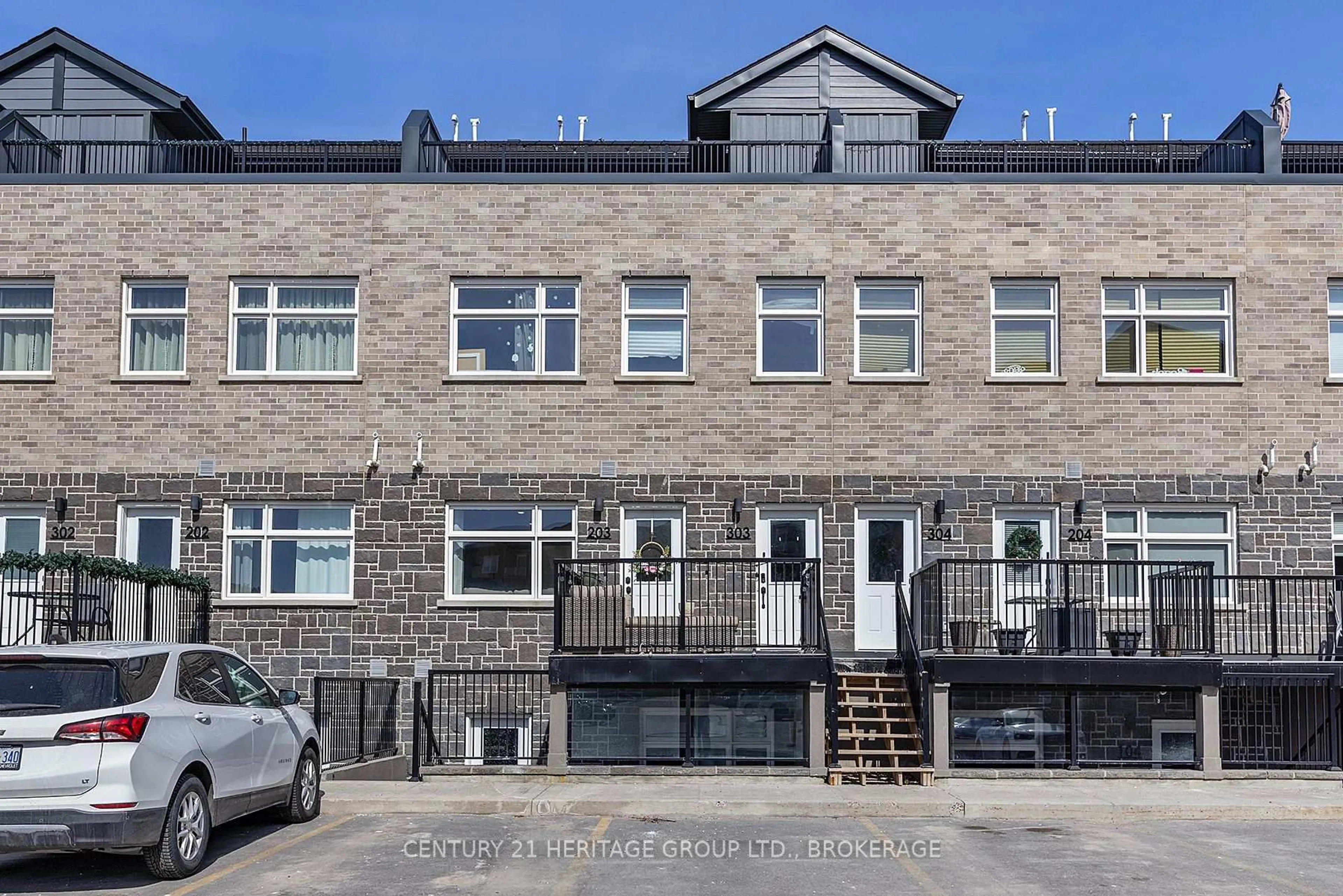 A pic from outside/outdoor area/front of a property/back of a property/a pic from drone, street for 809 Development Dr #203, Kingston Ontario K7M 0J4