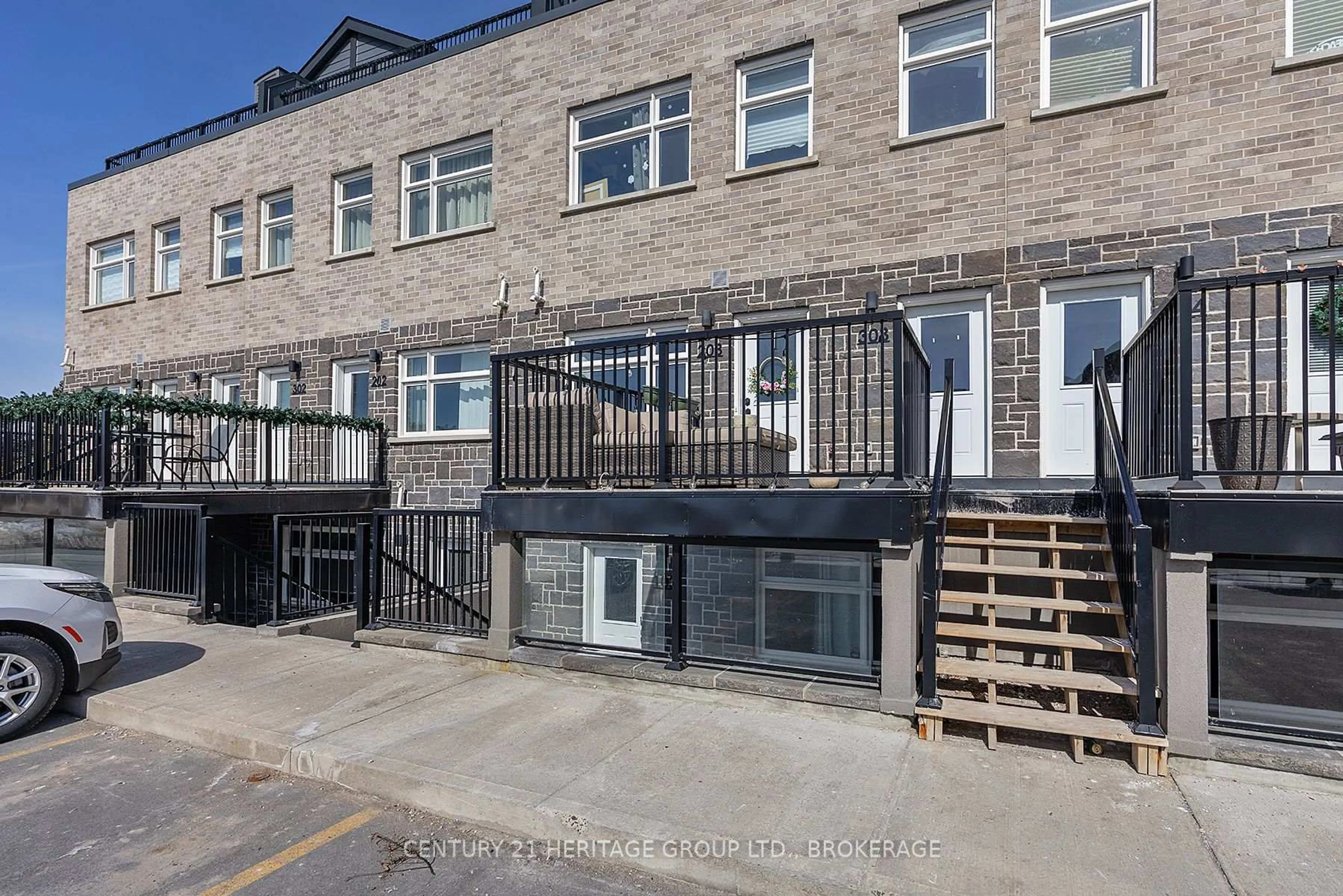 A pic from outside/outdoor area/front of a property/back of a property/a pic from drone, street for 809 Development Dr #203, Kingston Ontario K7M 0J4
