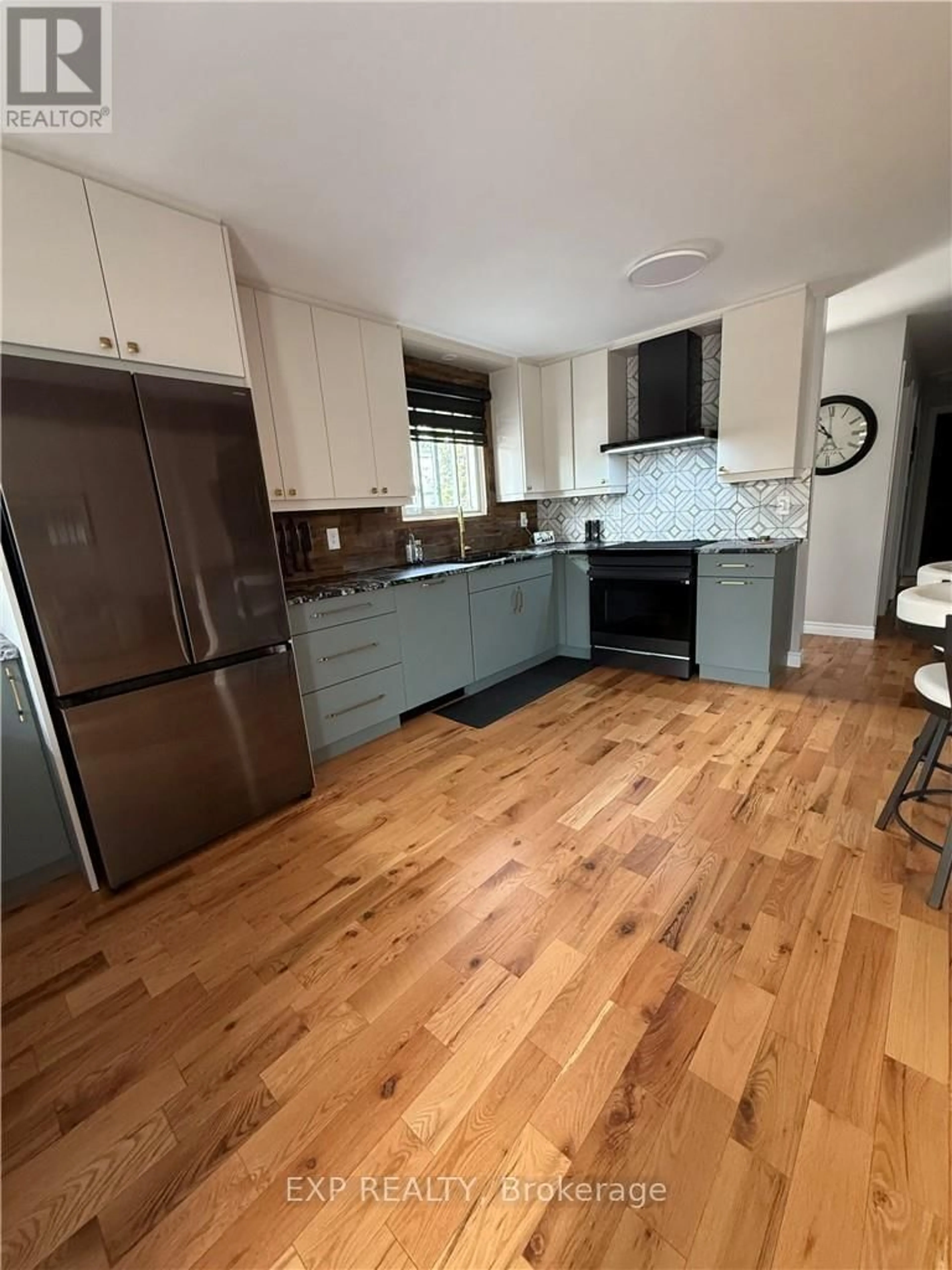 Open concept kitchen, wood/laminate floor for 3135 Louis St, Greater Sudbury Ontario P3N 1B9