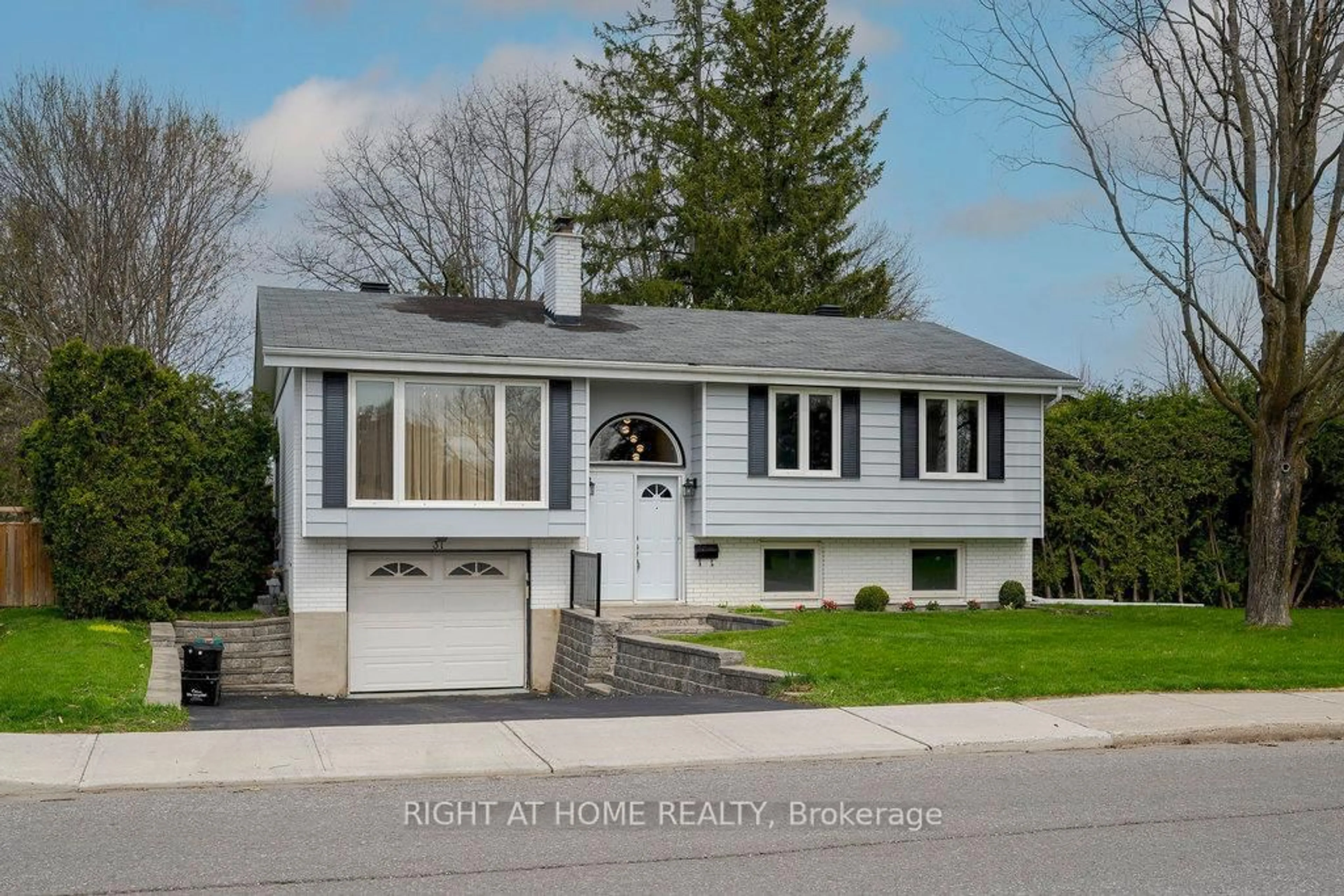 Home with vinyl exterior material, street for 31 Ashgrove Cres, Ottawa Ontario K2G 0S1