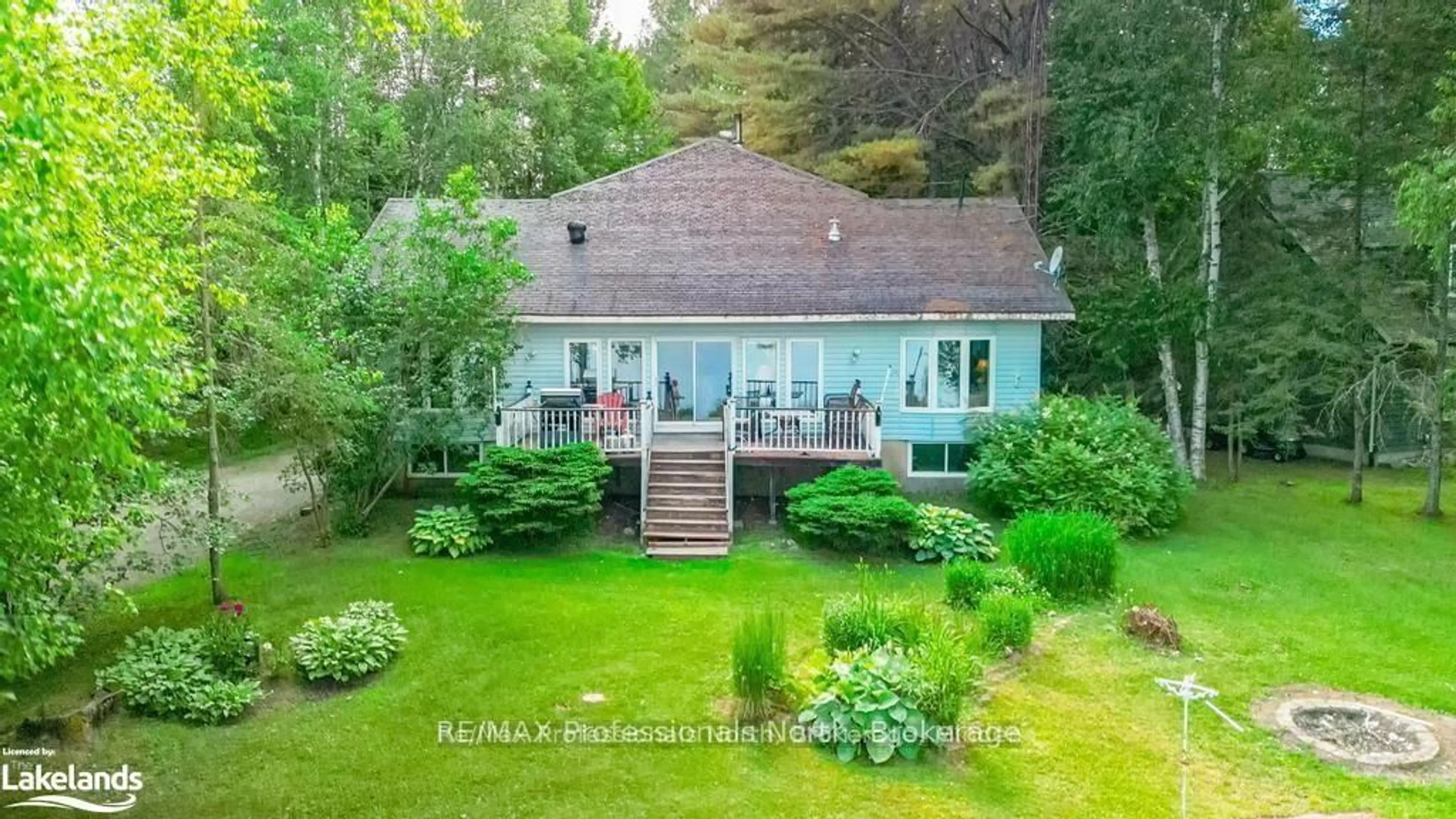 A pic from outside/outdoor area/front of a property/back of a property/a pic from drone, water/lake/river/ocean view for 1015 Blackberry Lane, Minden Hills Ontario K0M 2K0