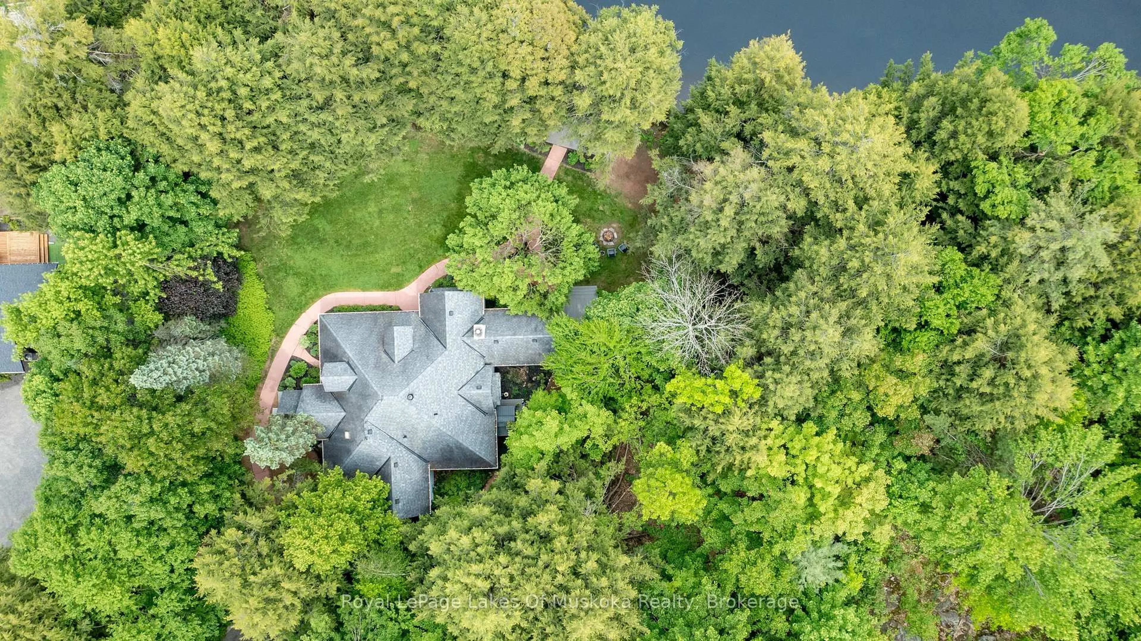 A pic from outside/outdoor area/front of a property/back of a property/a pic from drone, forest/trees view for 103 Southbank Dr, Bracebridge Ontario P1L 1G3
