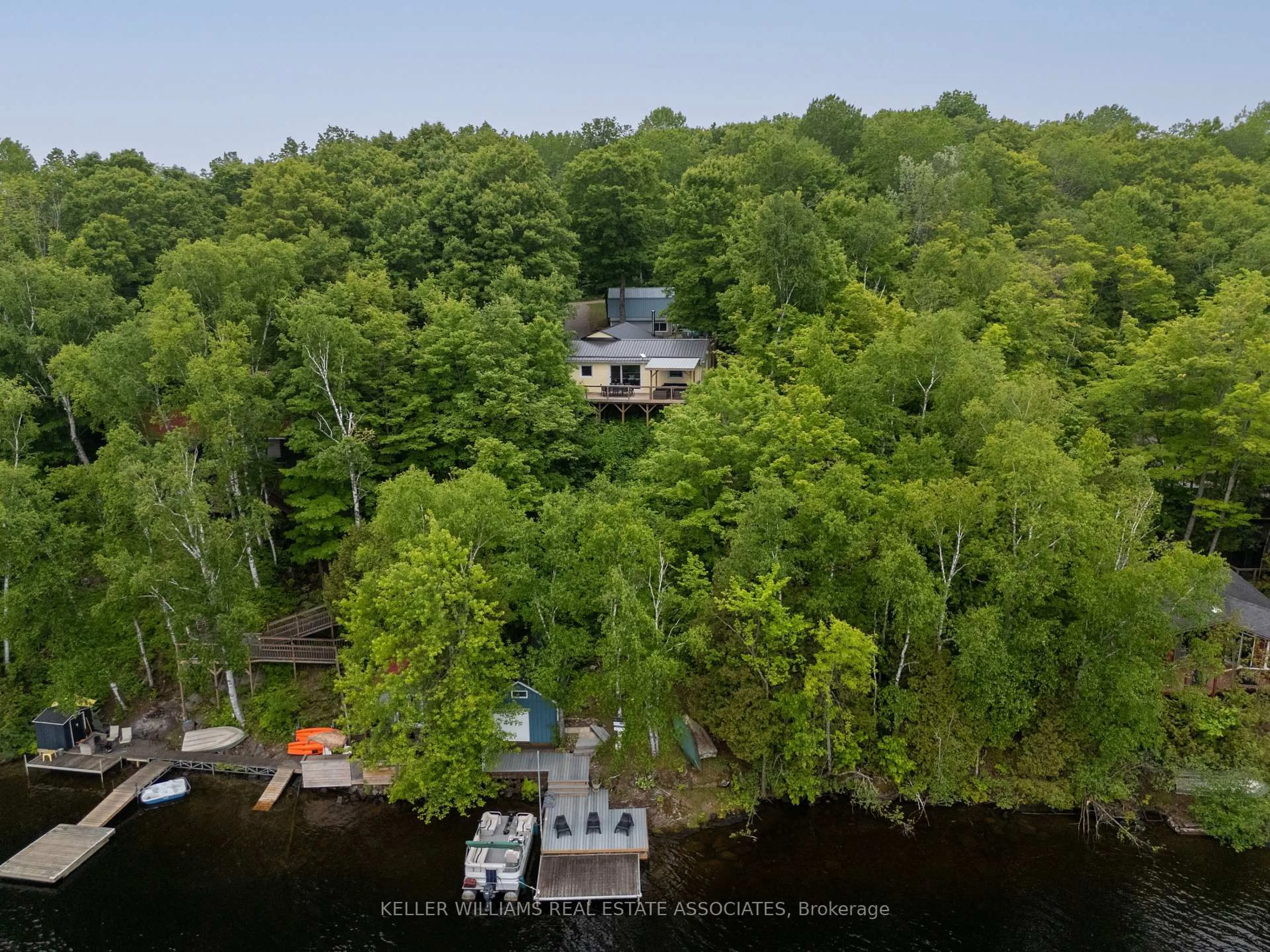 A pic from outside/outdoor area/front of a property/back of a property/a pic from drone, water/lake/river/ocean view for 398 Gilbert Bay Lane, Coe Hill Ontario K0L 1P0