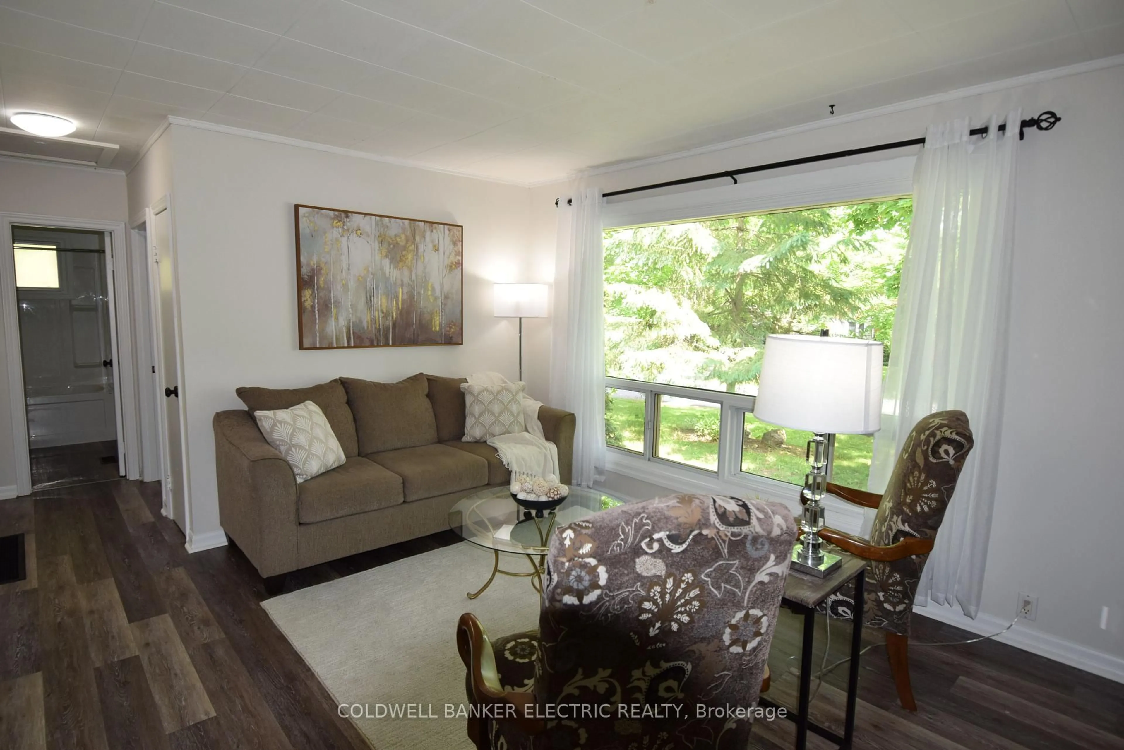 Living room with furniture, wood/laminate floor for 281 Collison Ave, Peterborough South Ontario K9J 1A5