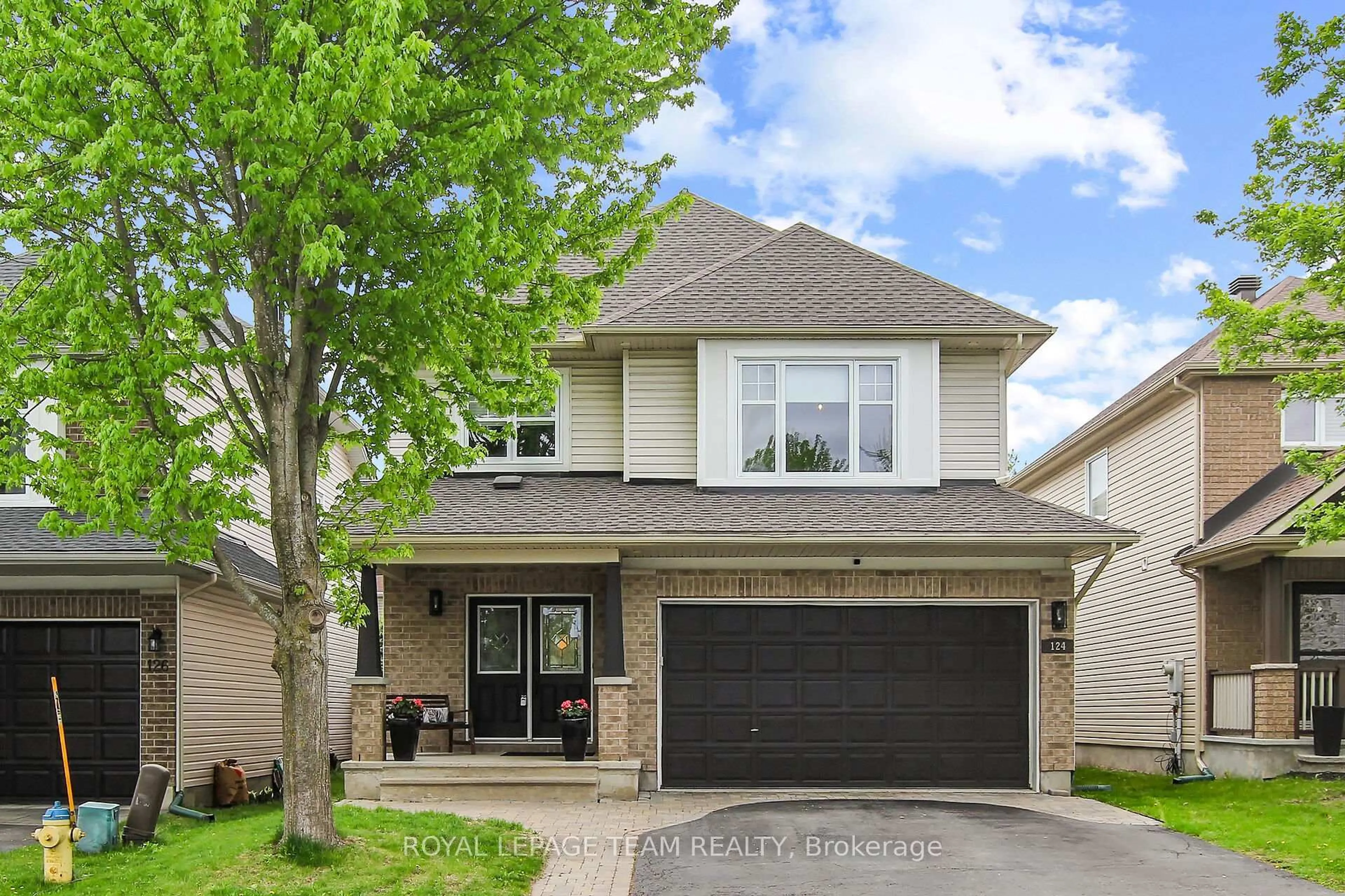 Home with brick exterior material, street for 124 Versilia Dr, Ottawa Ontario K2G 7E2