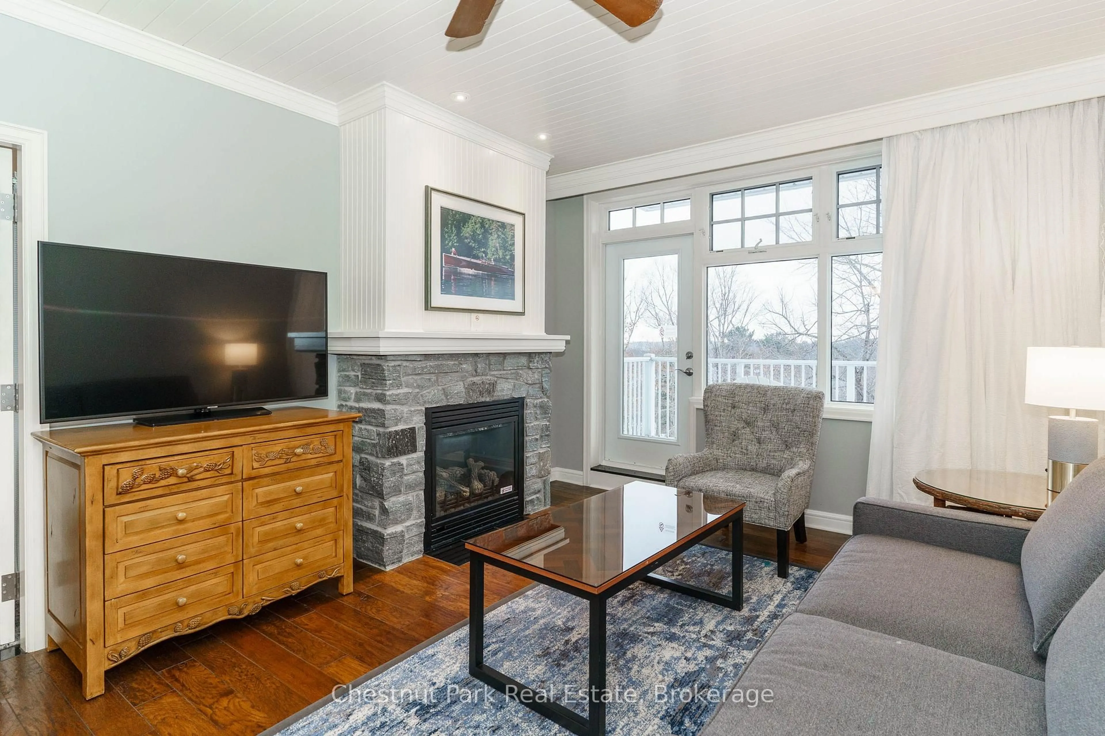 Living room with furniture, wood/laminate floor for 1050 PAIGNTON HOUSE Rd #1225, Muskoka Lakes Ontario P0B 1G0