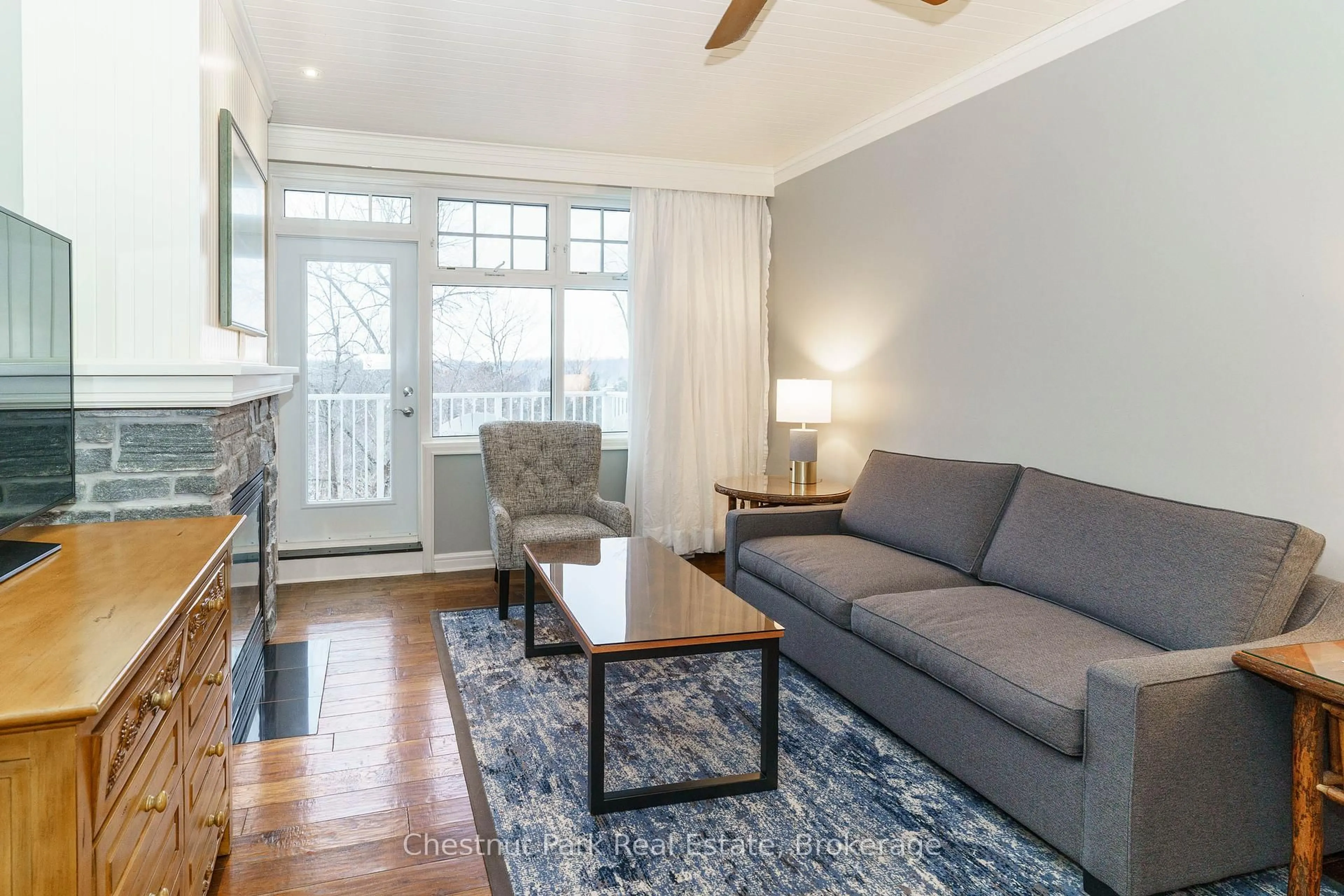 Living room with furniture, wood/laminate floor for 1050 PAIGNTON HOUSE Rd #1225, Muskoka Lakes Ontario P0B 1G0