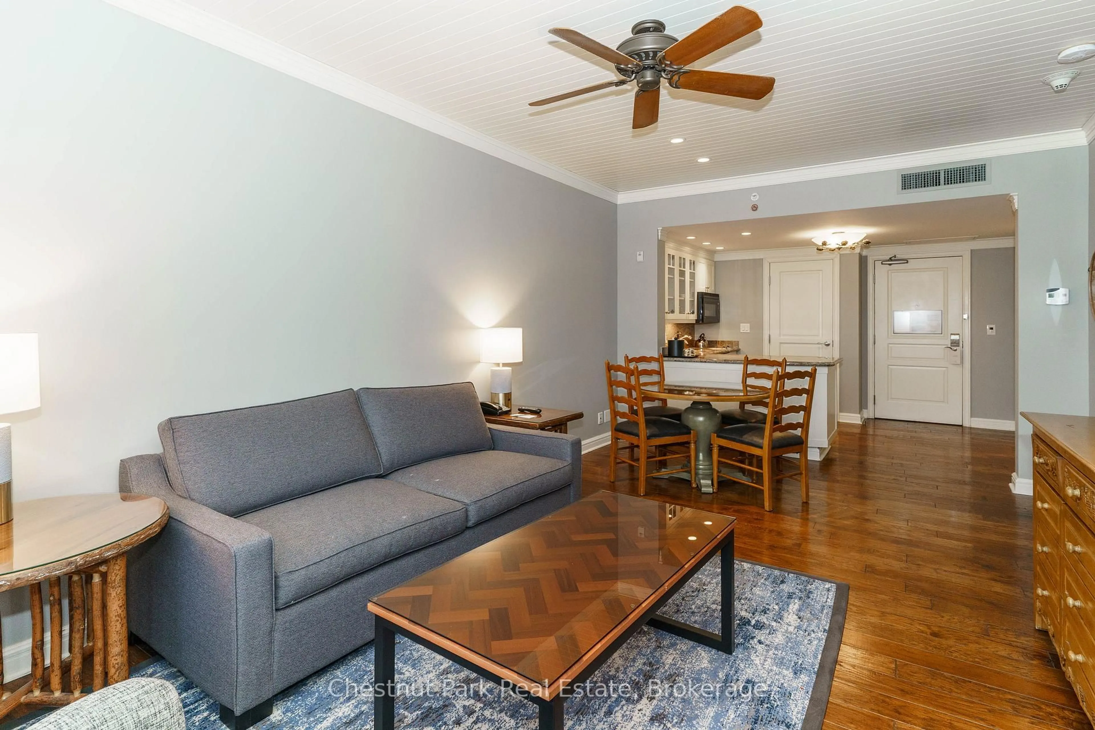 Living room with furniture, wood/laminate floor for 1050 PAIGNTON HOUSE Rd #1225, Muskoka Lakes Ontario P0B 1G0