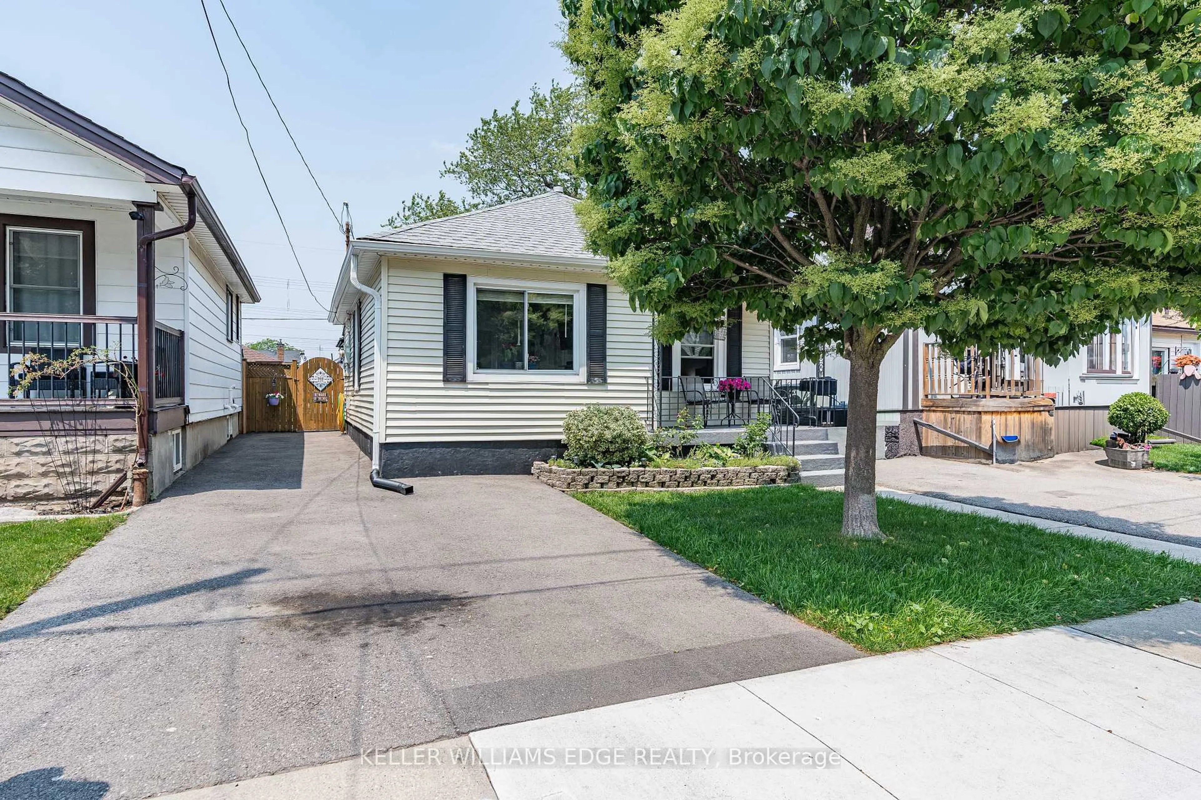 Home with vinyl exterior material, street for 235 Tolton Ave, Hamilton Ontario L8H 5P2