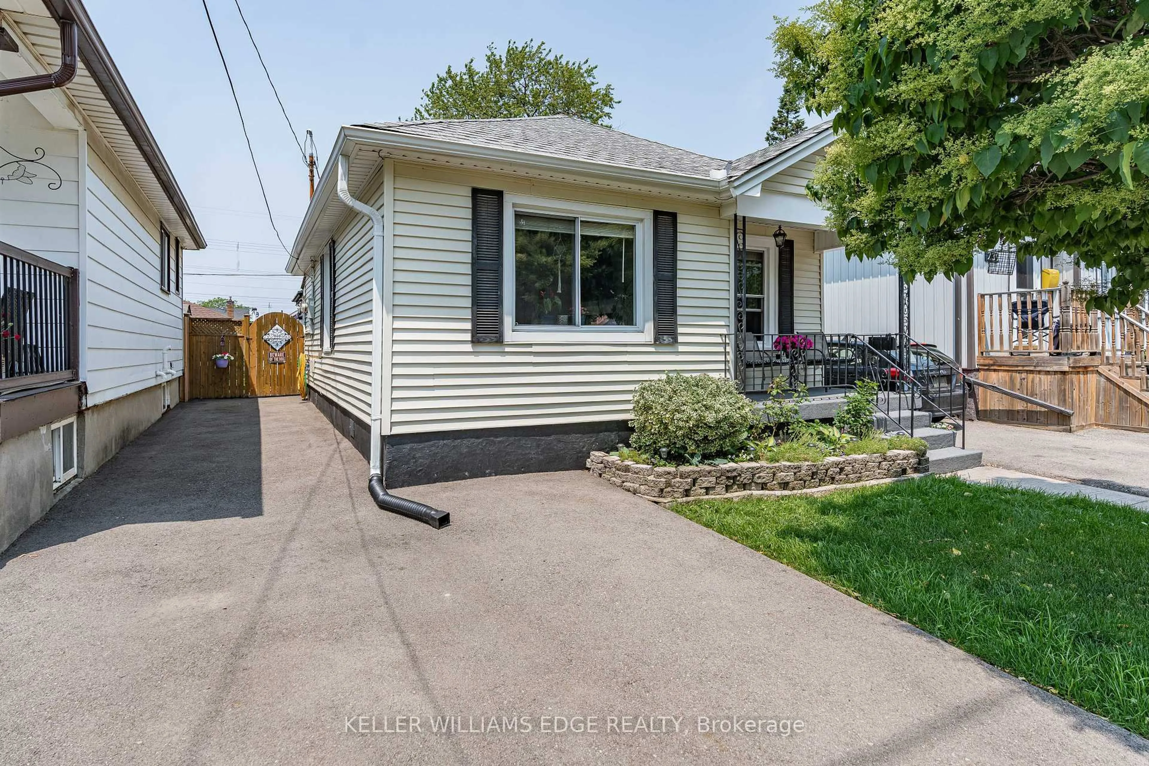 Home with vinyl exterior material, street for 235 Tolton Ave, Hamilton Ontario L8H 5P2