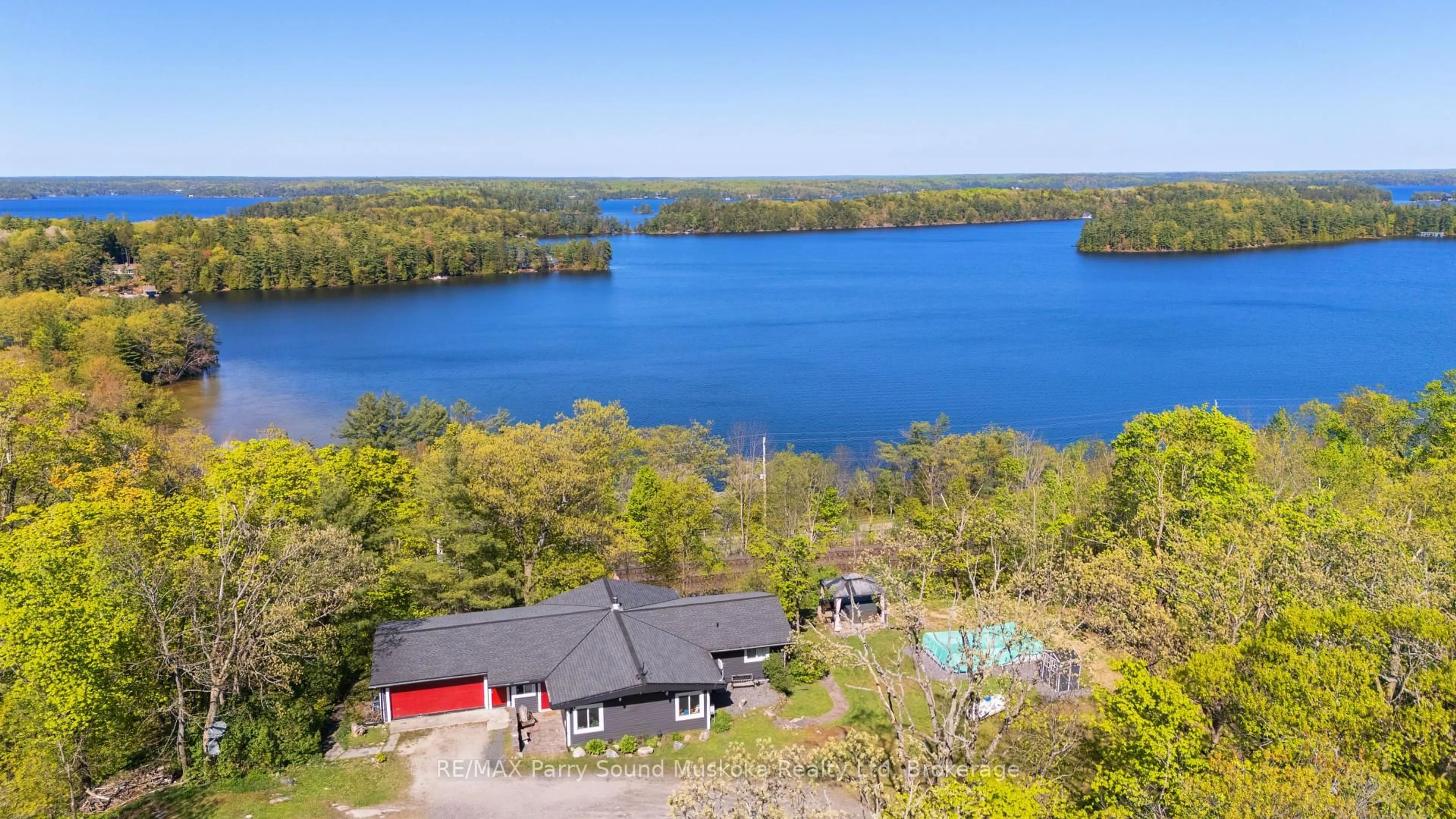 A pic from outside/outdoor area/front of a property/back of a property/a pic from drone, water/lake/river/ocean view for 143A Highway 612, Seguin Ontario P0C 1H0