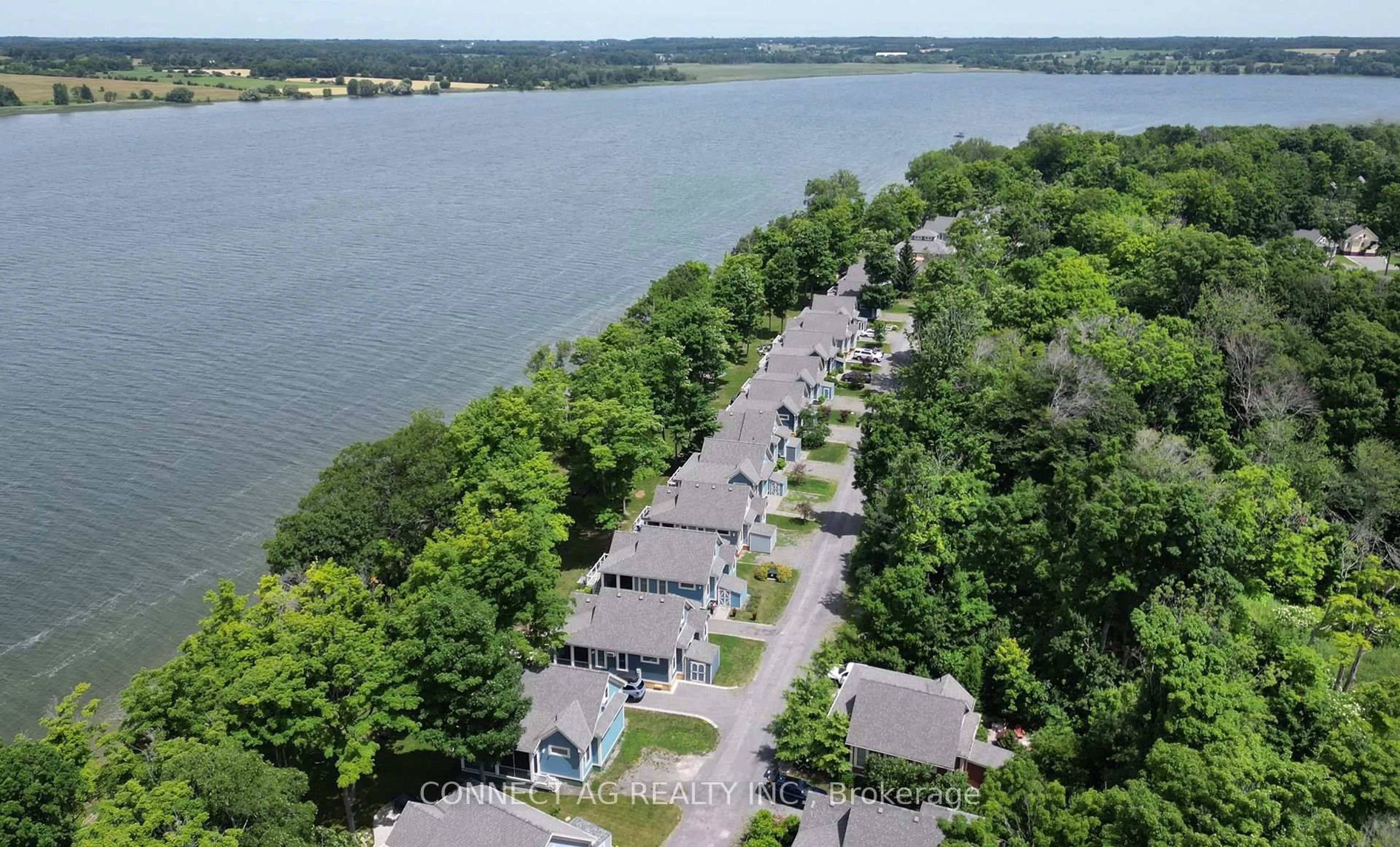A pic from outside/outdoor area/front of a property/back of a property/a pic from drone, water/lake/river/ocean view for 44 Summer Village Lane #236, Prince Edward County Ontario K0K 1P0