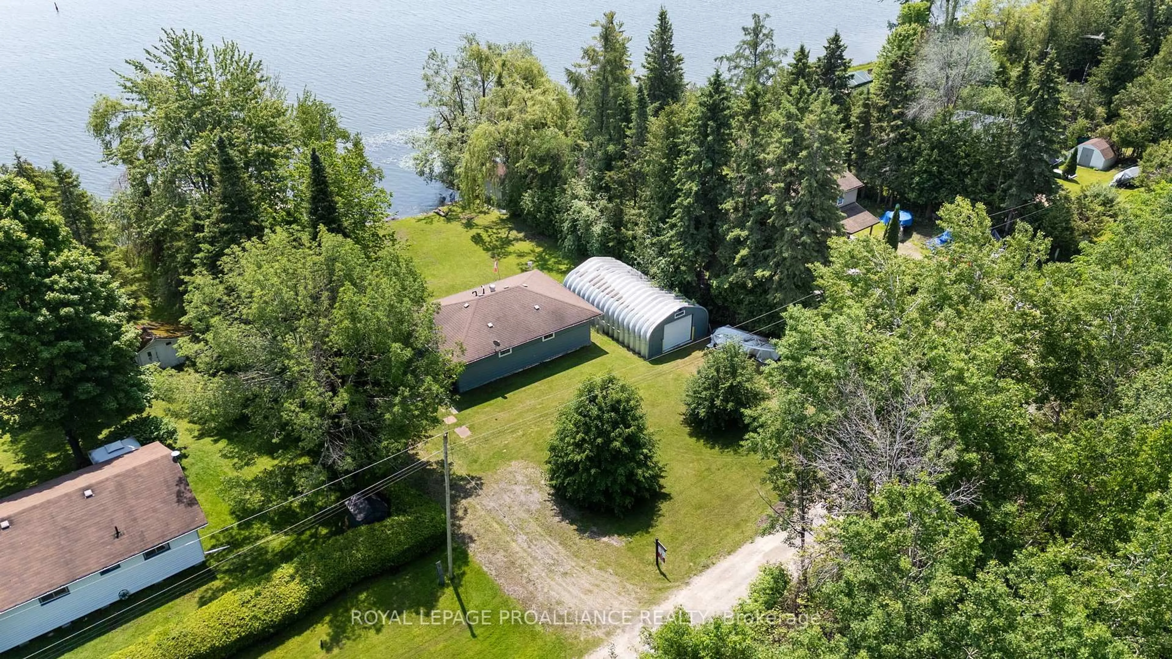 A pic from outside/outdoor area/front of a property/back of a property/a pic from drone, water/lake/river/ocean view for 70 Beach Rd, Kawartha Lakes Ontario K0M 2C0