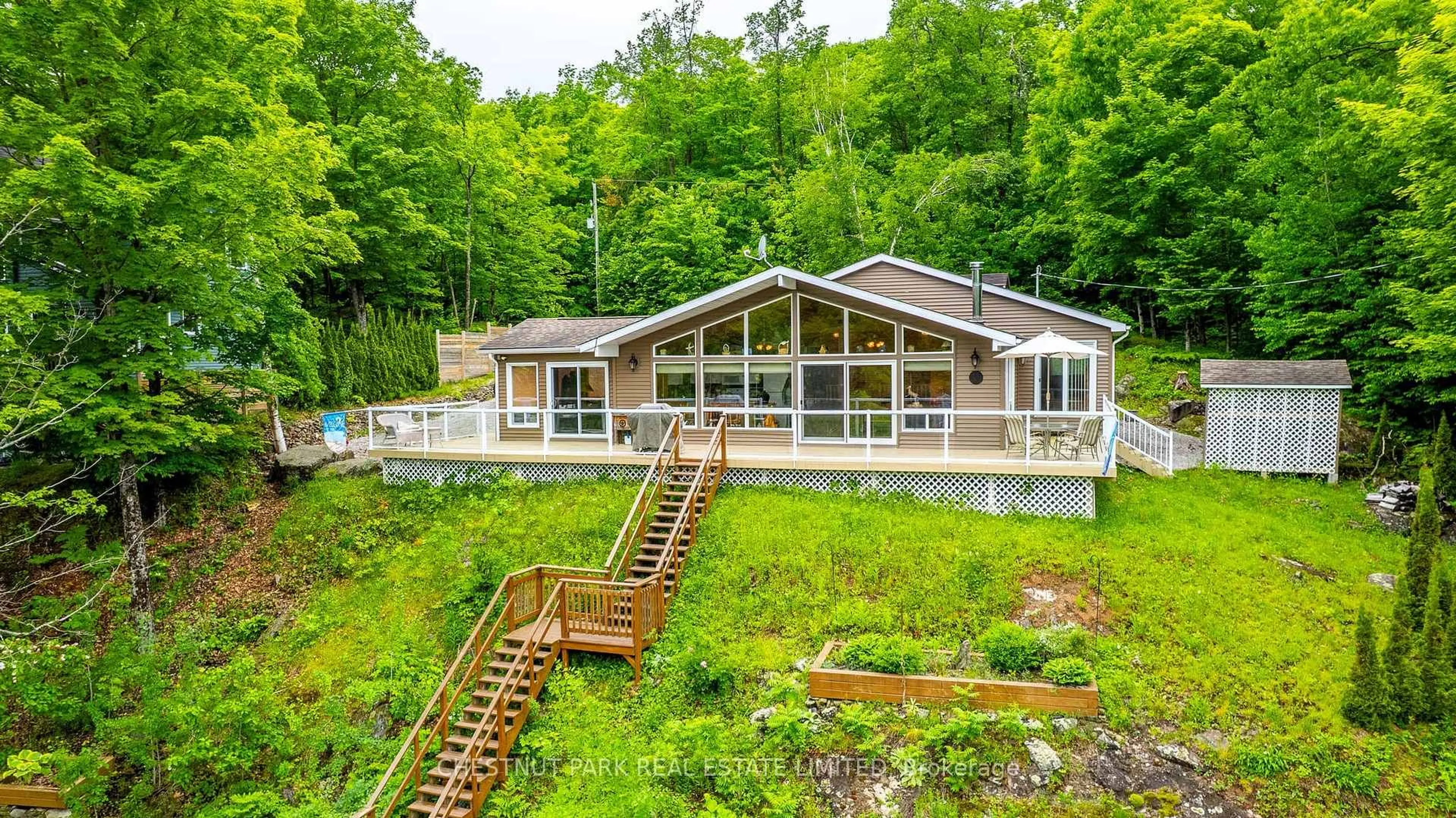 A pic from outside/outdoor area/front of a property/back of a property/a pic from drone, water/lake/river/ocean view for 1601 Claude Brown Rd, Minden Hills Ontario K0M 2K0