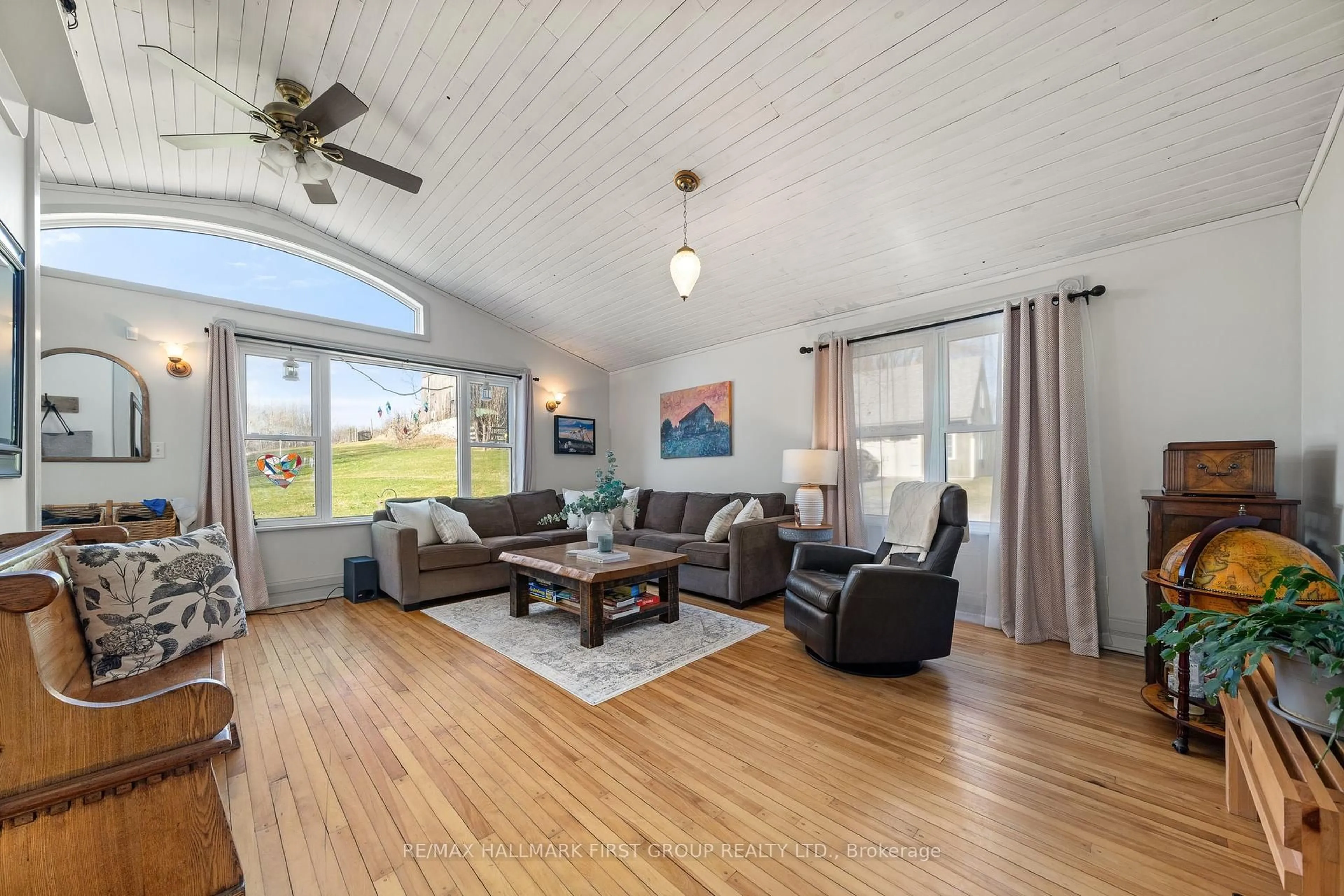 Living room with furniture, wood/laminate floor for 16882 Telephone Rd, Ingleside Ontario K8V 5P4