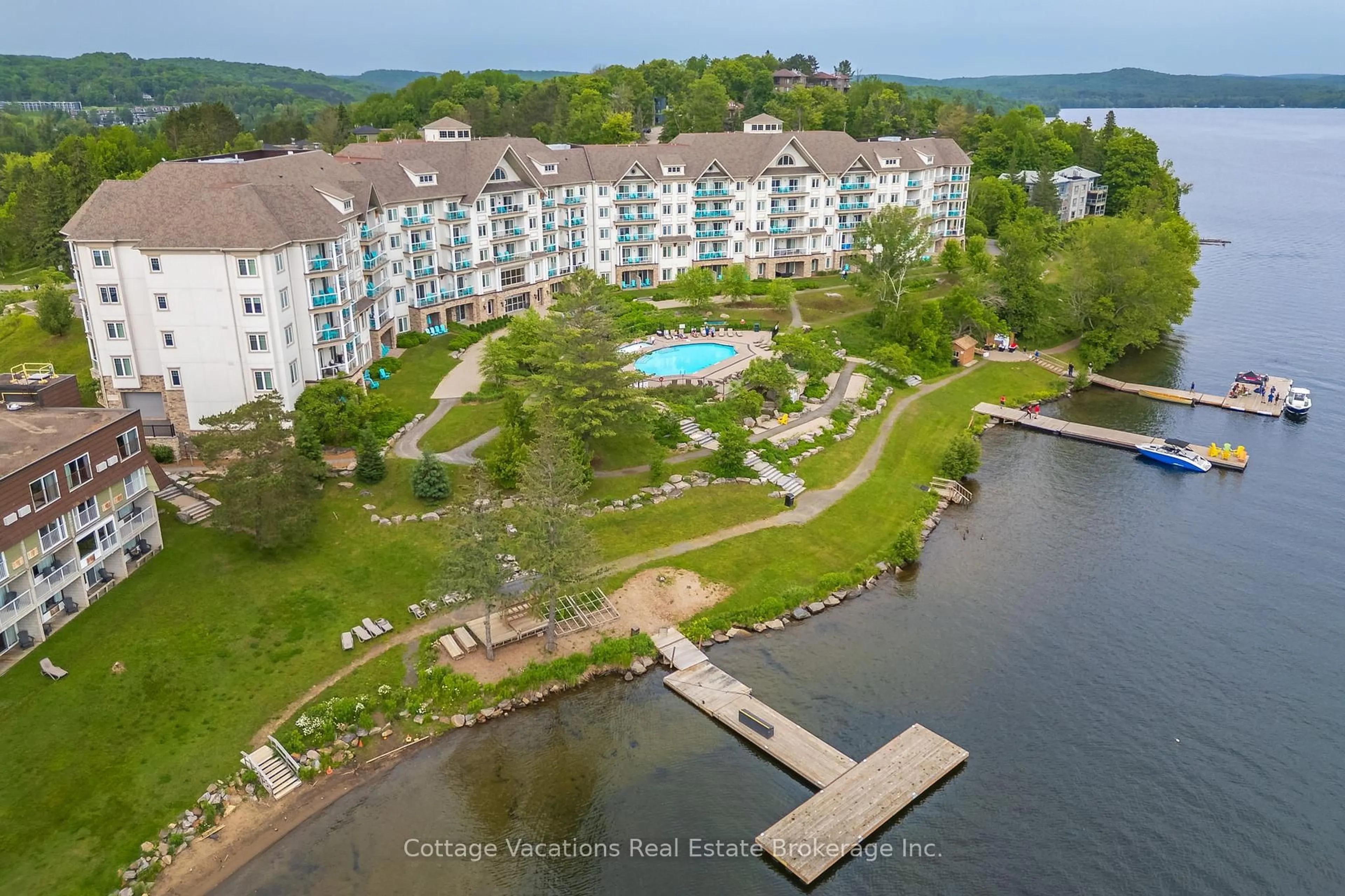 A pic from outside/outdoor area/front of a property/back of a property/a pic from drone, water/lake/river/ocean view for 25 Pen Lake Pt #314, Huntsville Ontario P1H 1A9