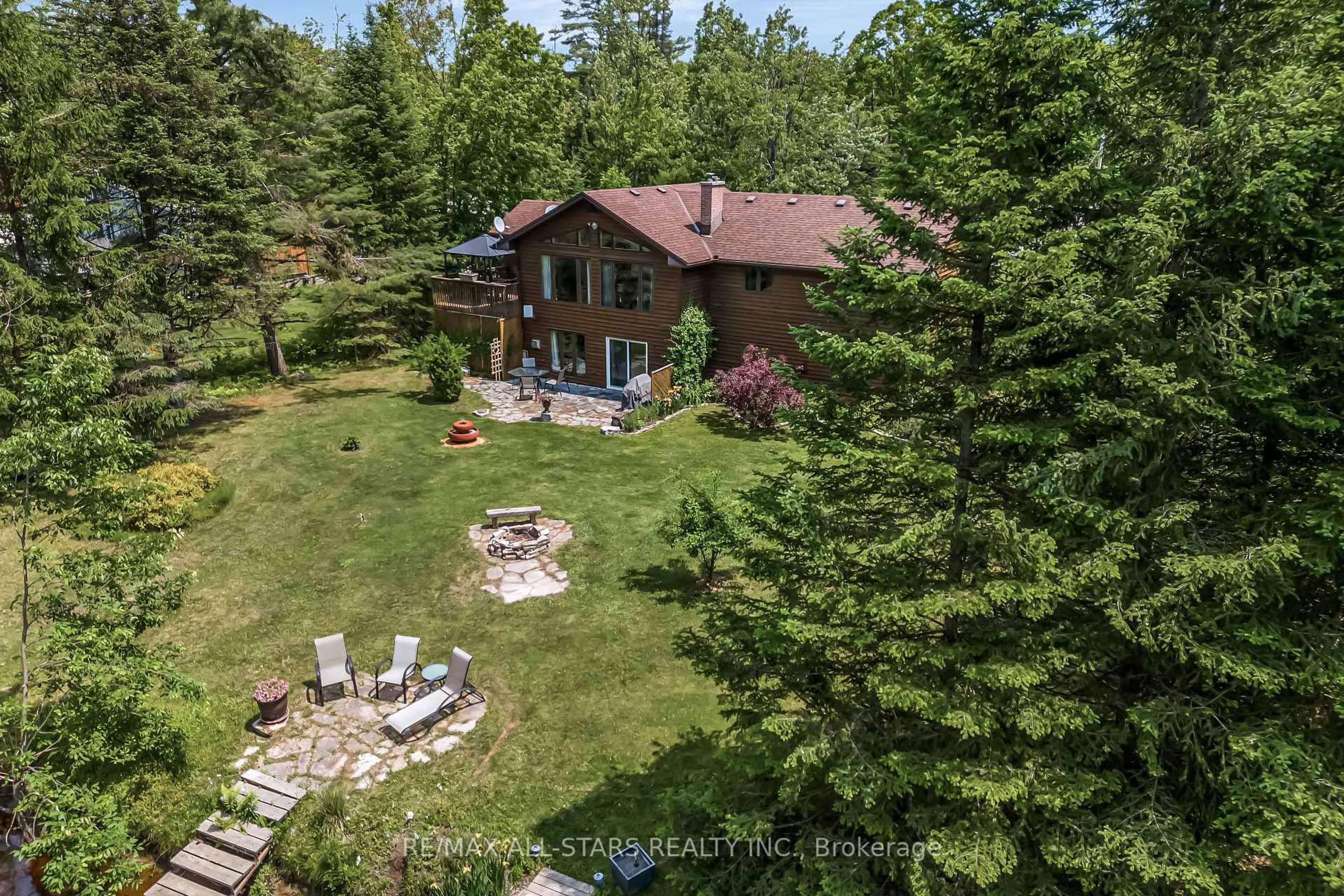 A pic from outside/outdoor area/front of a property/back of a property/a pic from drone, forest/trees view for 98 Edwina Dr, Trent Lakes Ontario K0M 1A0