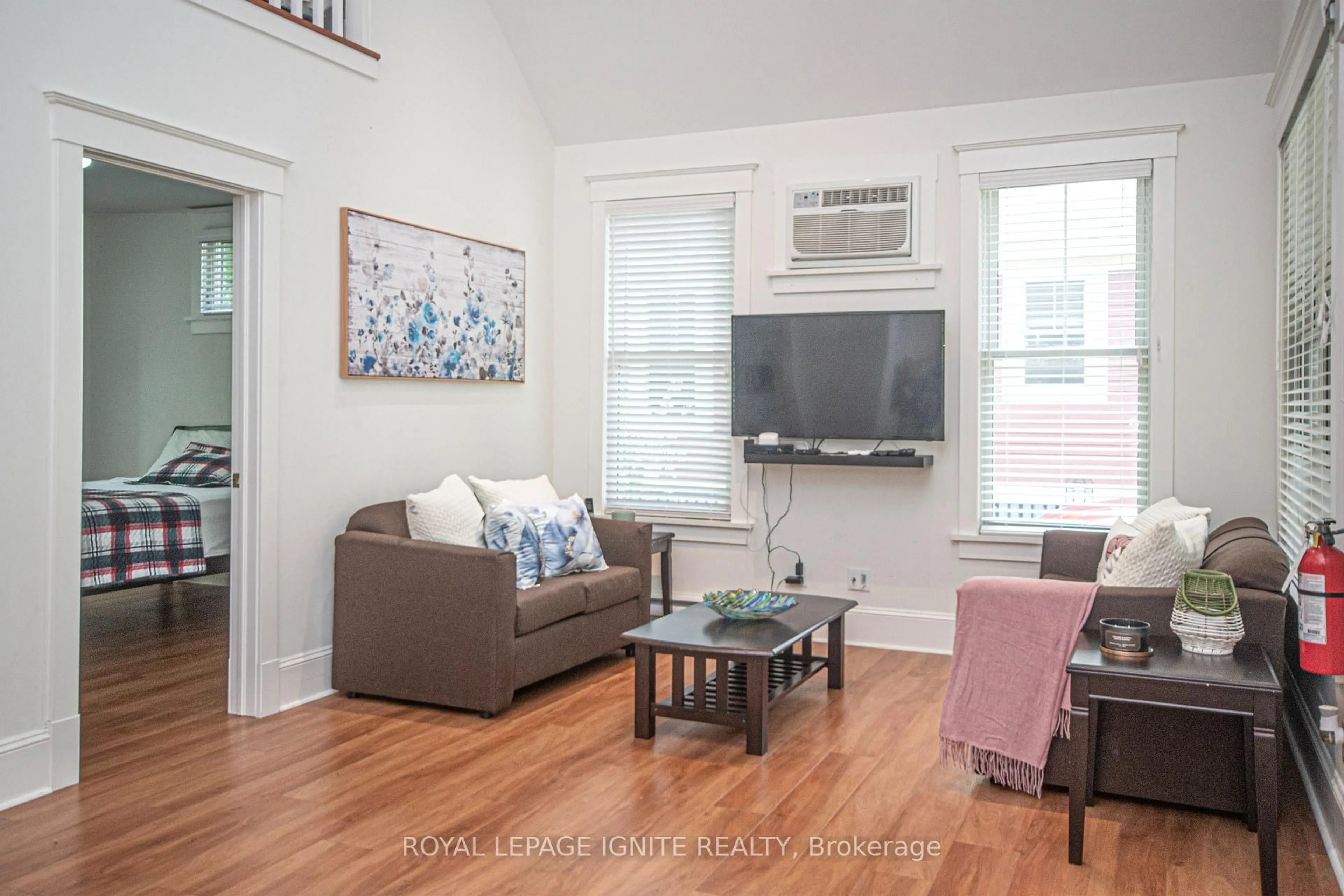 Living room with furniture, wood/laminate floor for 19 Summer Village Lane #208, Prince Edward County Ontario K0K 1P0