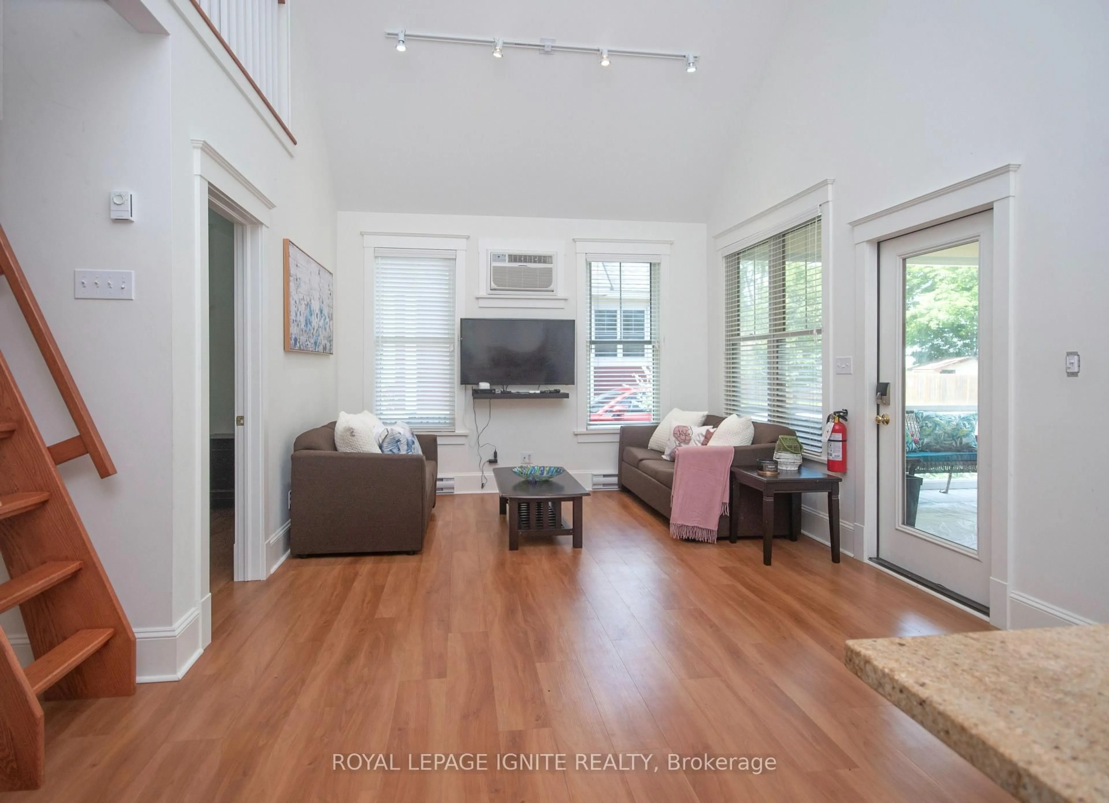 Living room with furniture, wood/laminate floor for 19 Summer Village Lane #208, Prince Edward County Ontario K0K 1P0