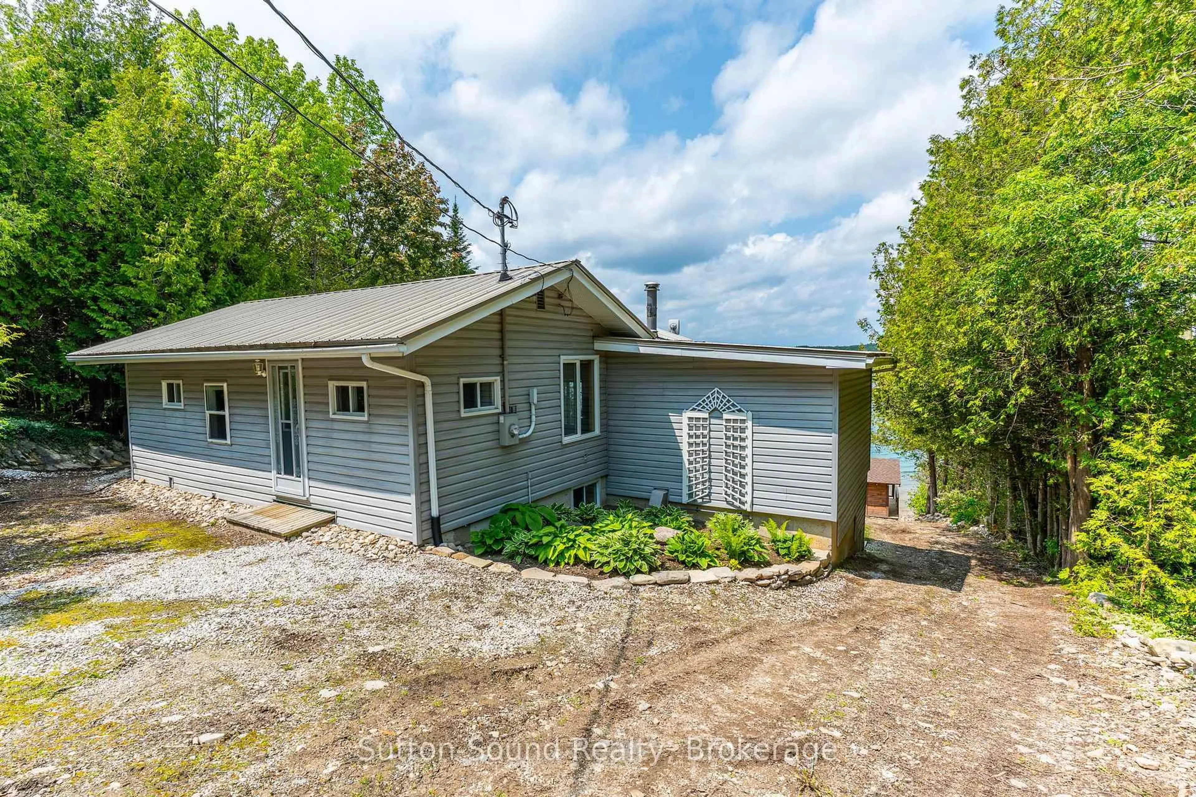 A pic from outside/outdoor area/front of a property/back of a property/a pic from drone, street for 503185 Grey Road 1 Rd, Georgian Bluffs Ontario N0H 2T0