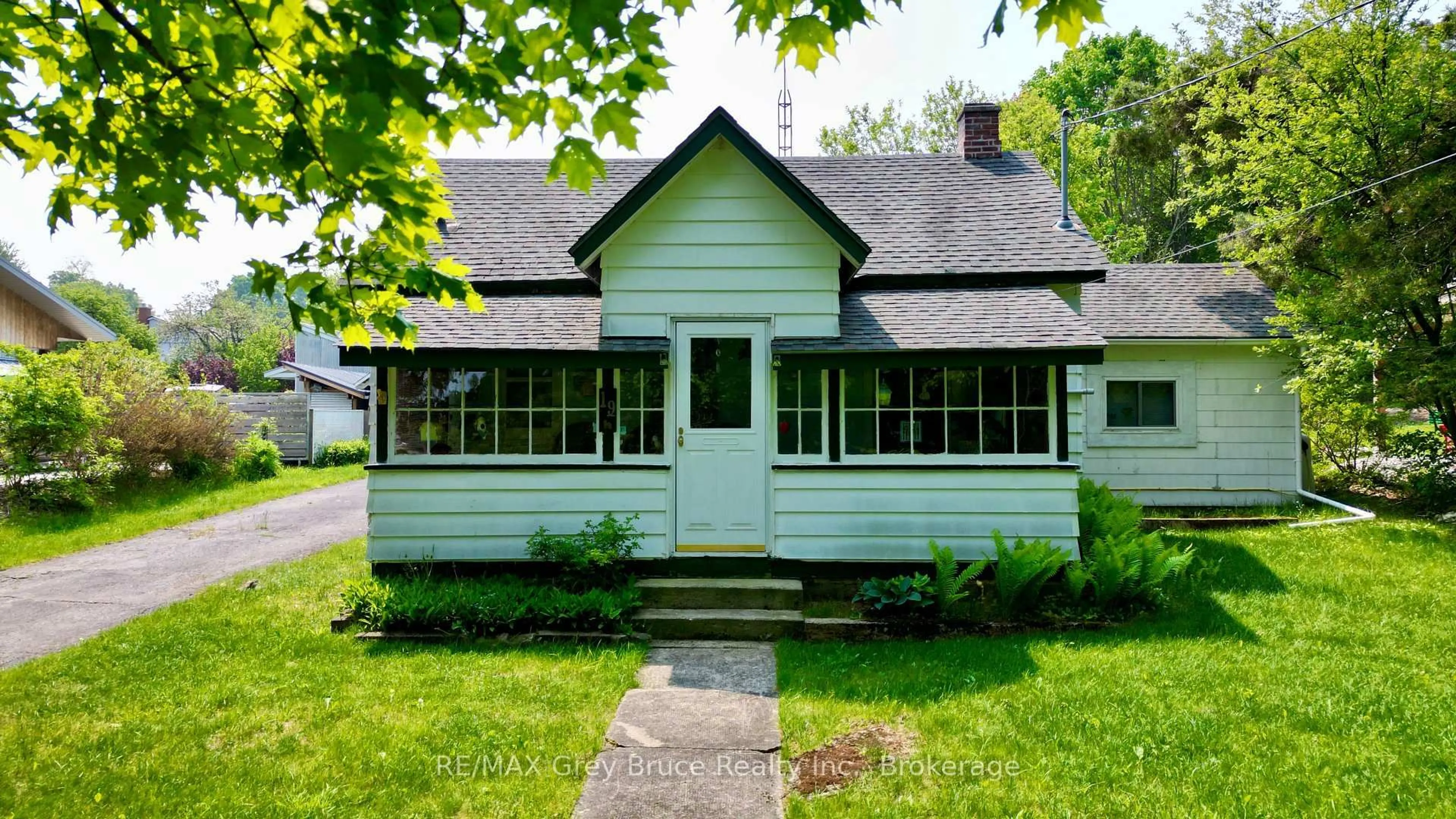 Home with vinyl exterior material, street for 19 Mill St, Northern Bruce Peninsula Ontario N0H 1W0