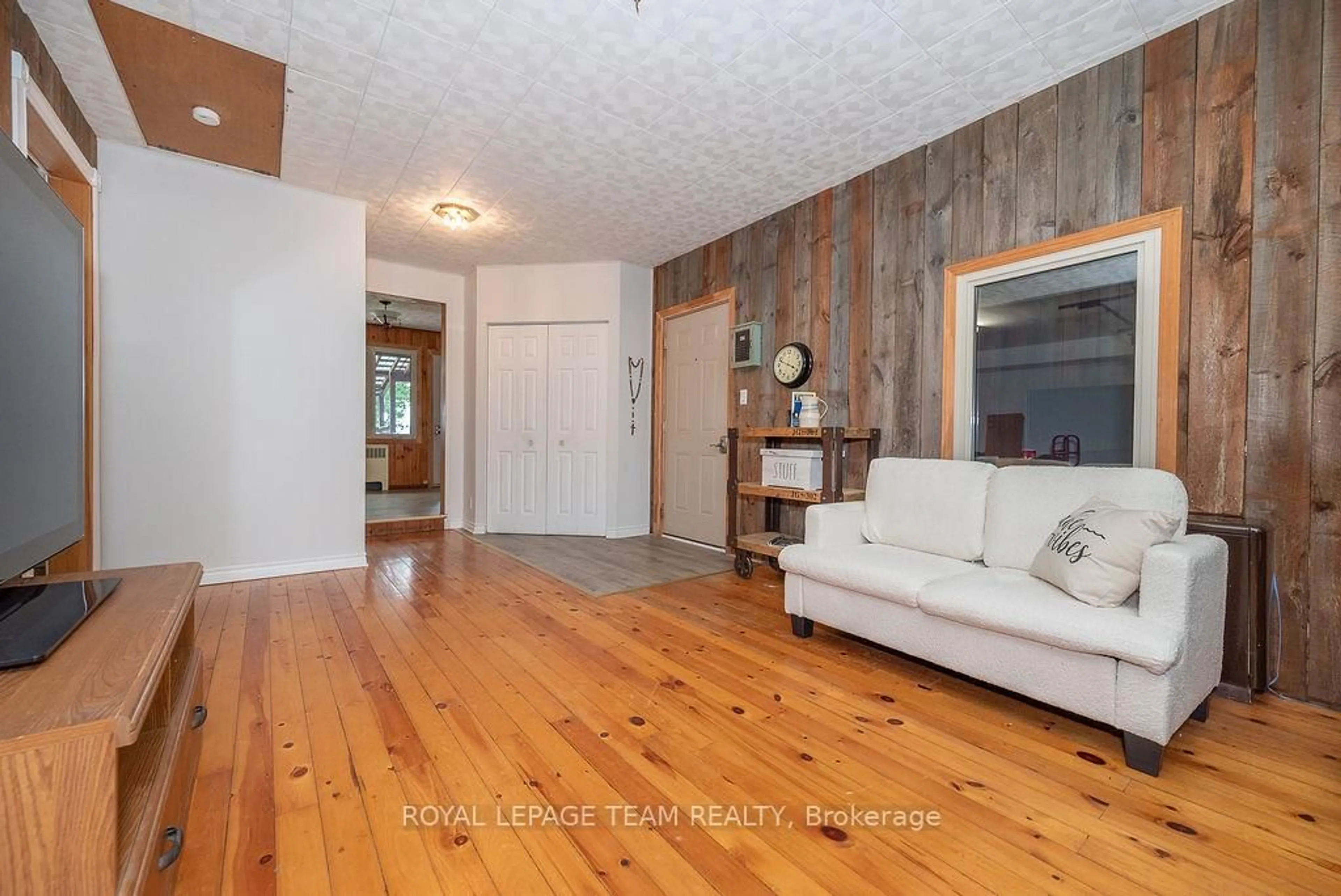 Living room with furniture, wood/laminate floor for 42165 Combermere Rd, Barry's Bay Ontario K0J 1B0