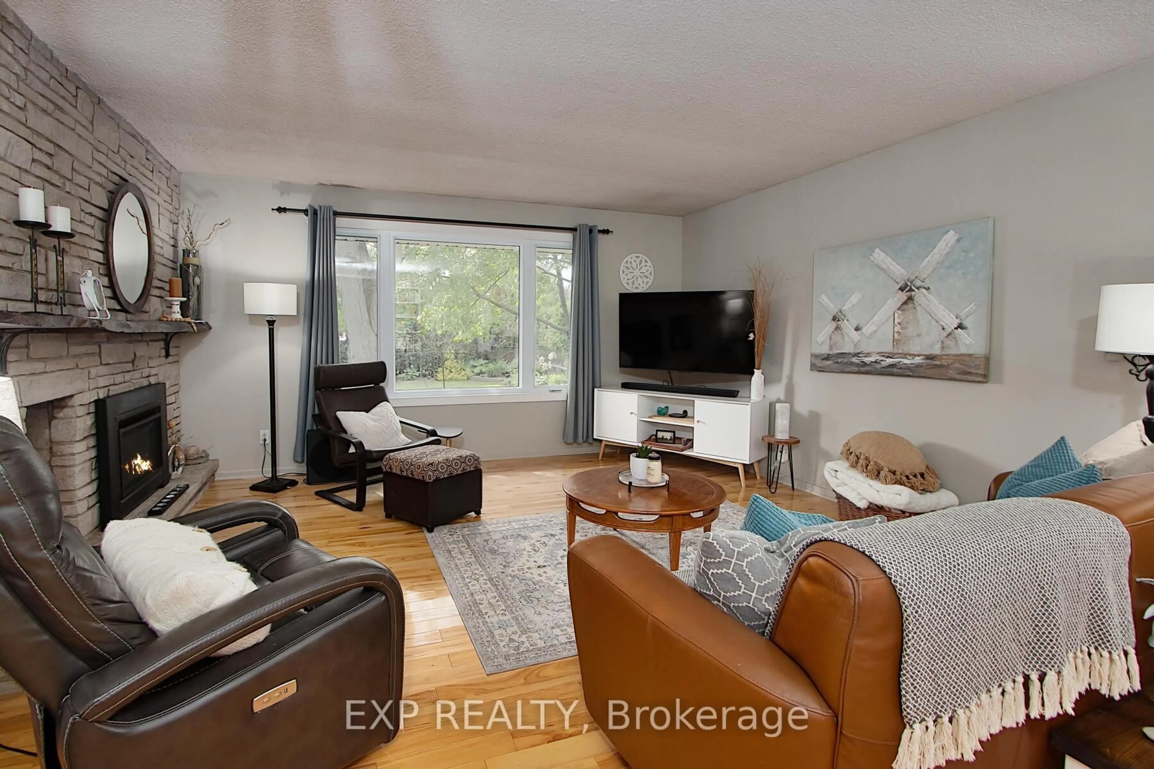 Living room with furniture, wood/laminate floor for 1183 Addison Dr, London East Ontario N5V 2N8