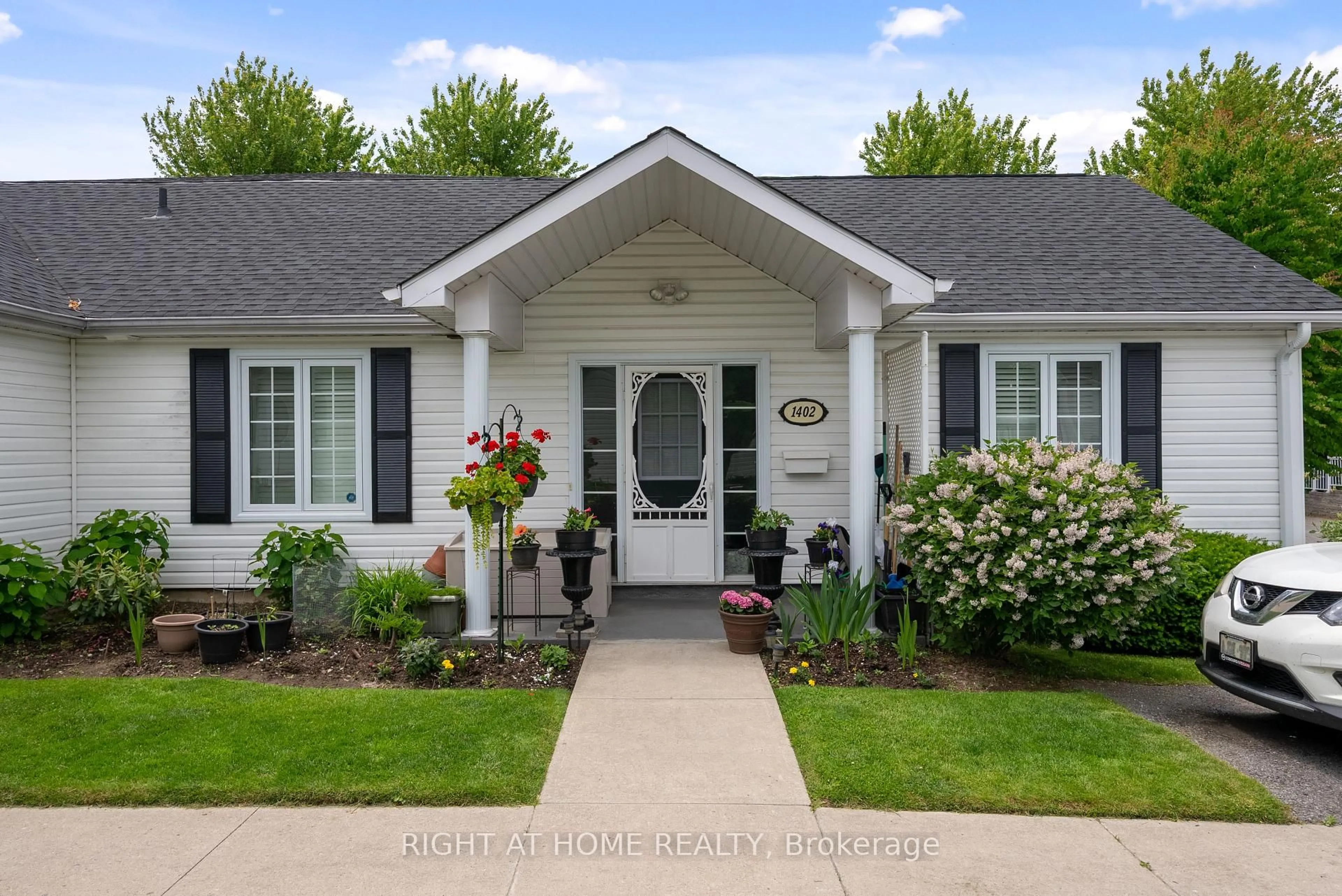 Home with vinyl exterior material, street for 1055 Birchwood Tr #1402, Cobourg Ontario K9A 5Y2