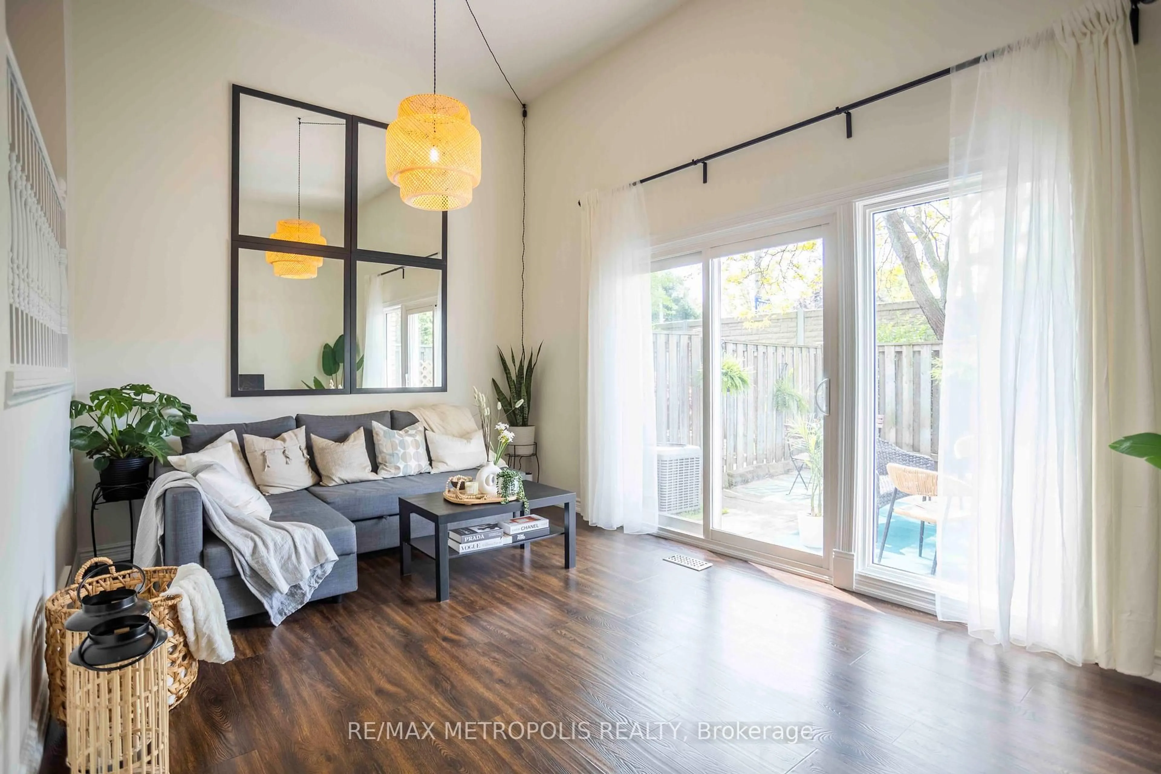 Living room with furniture, wood/laminate floor for 11 Harrisford St #57, Hamilton Ontario L8K 6L7