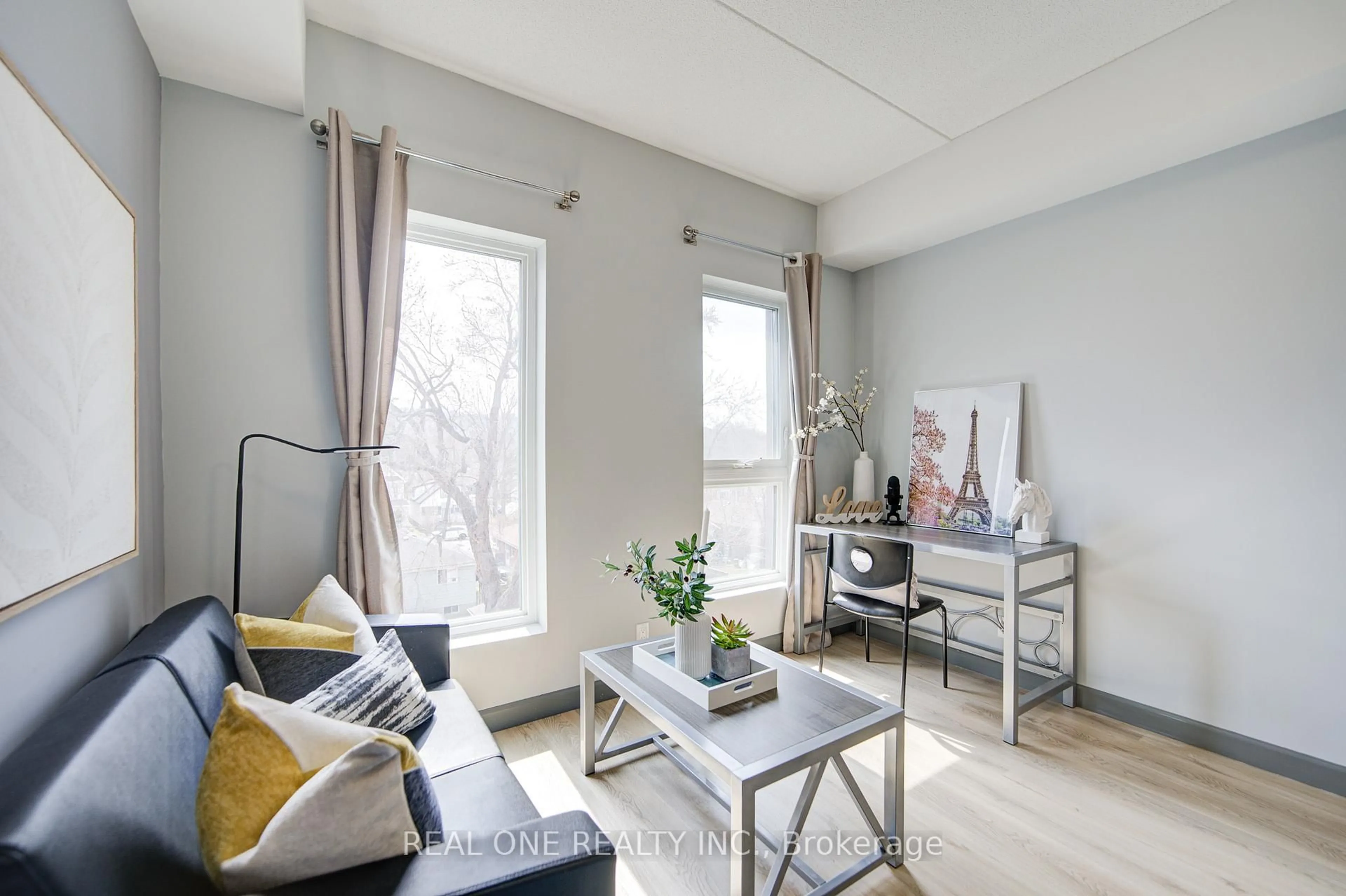 Living room with furniture, wood/laminate floor for 77 Leland St #423, Hamilton Ontario L8S 3A1