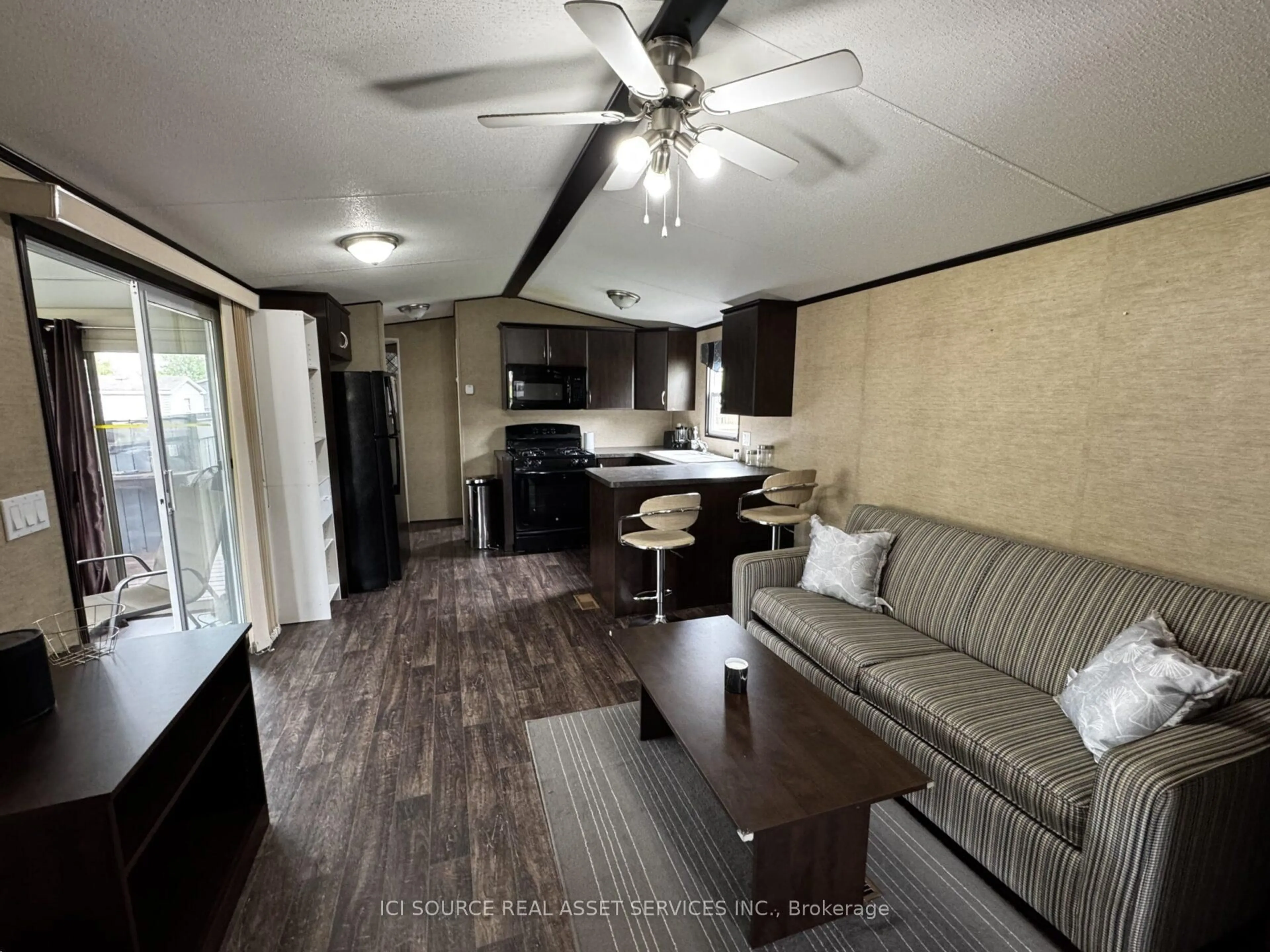 Living room with furniture, wood/laminate floor for 1235 Villiers Line #LSC004, Otonabee-South Monaghan Ontario K0L 2G0