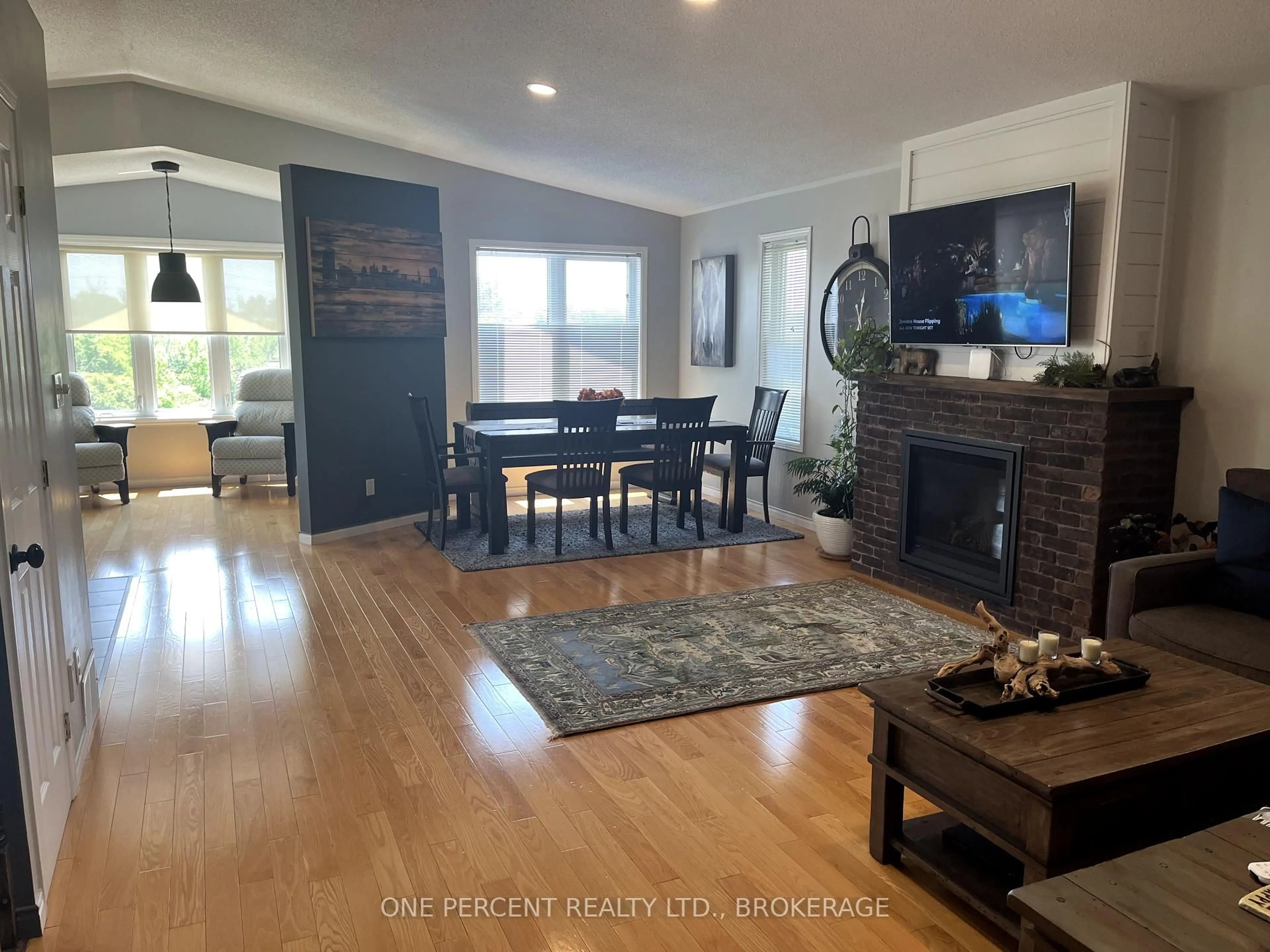 Living room with furniture, wood/laminate floor for 441 Dolshire St, Kingston Ontario K7M 9B5