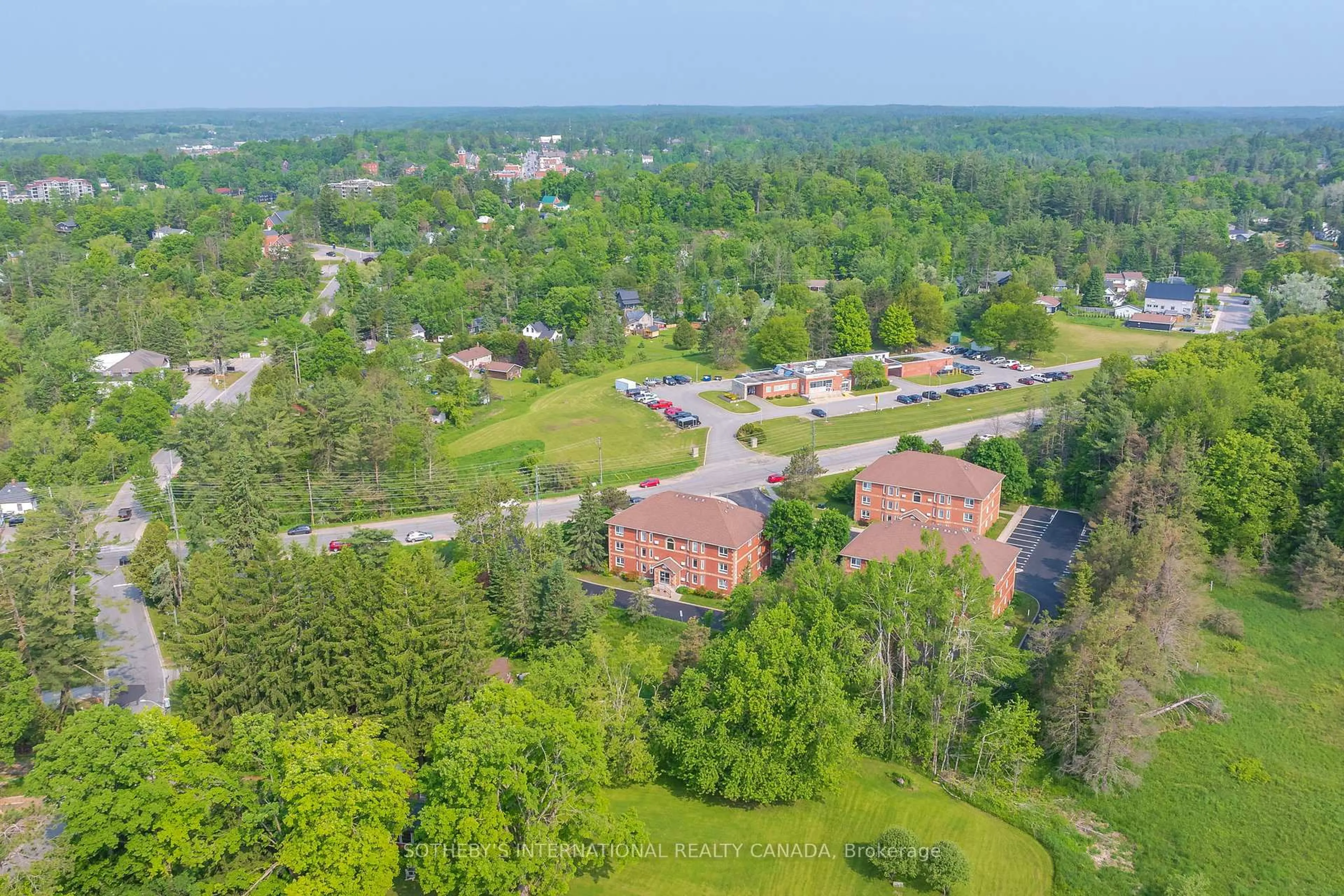A pic from outside/outdoor area/front of a property/back of a property/a pic from drone, mountain view for 661 Cedar Lane #201C, Bracebridge Ontario P1L 1N9