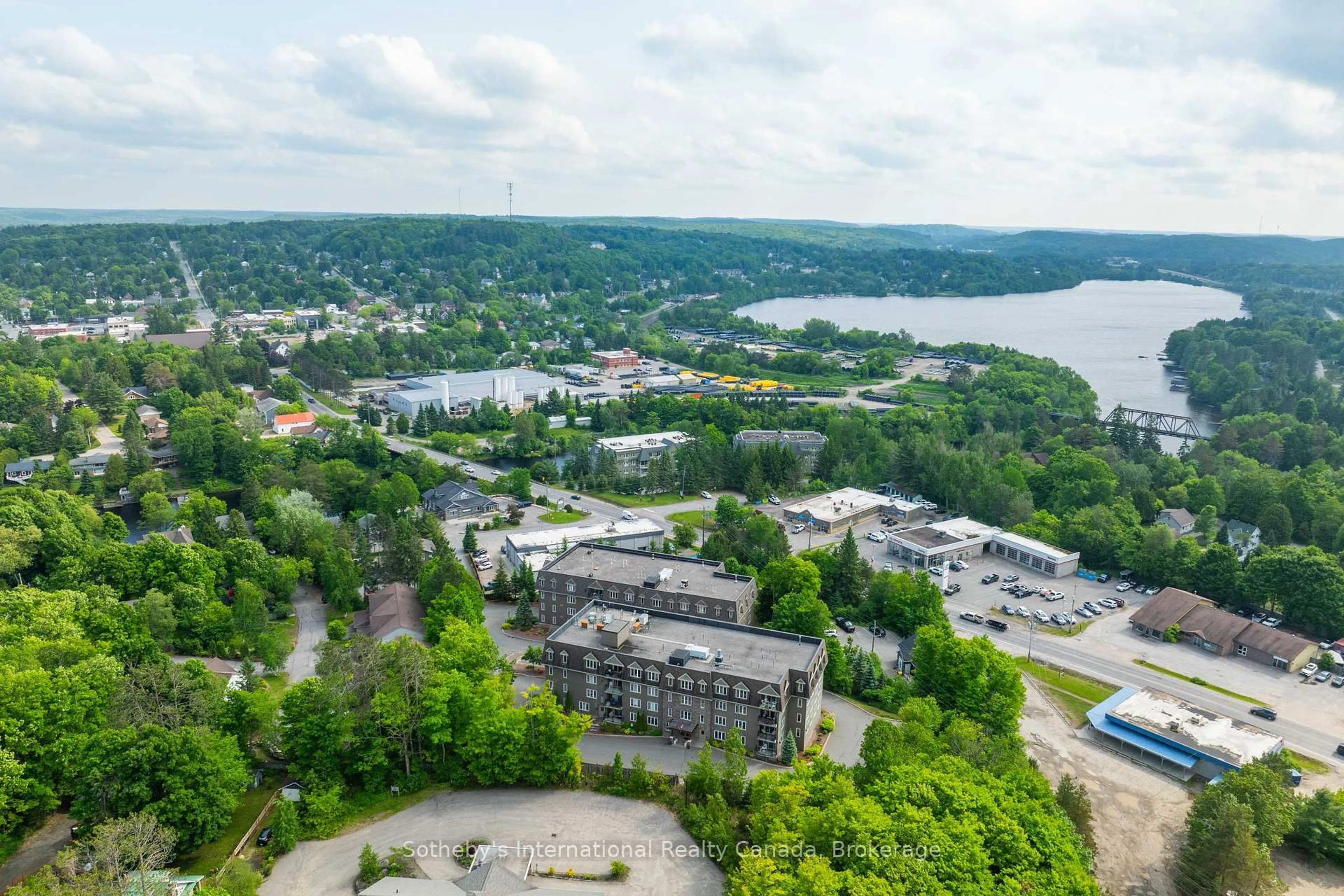 A pic from outside/outdoor area/front of a property/back of a property/a pic from drone, water/lake/river/ocean view for 26 Dairy Lane #303, Huntsville Ontario P1H 0A4