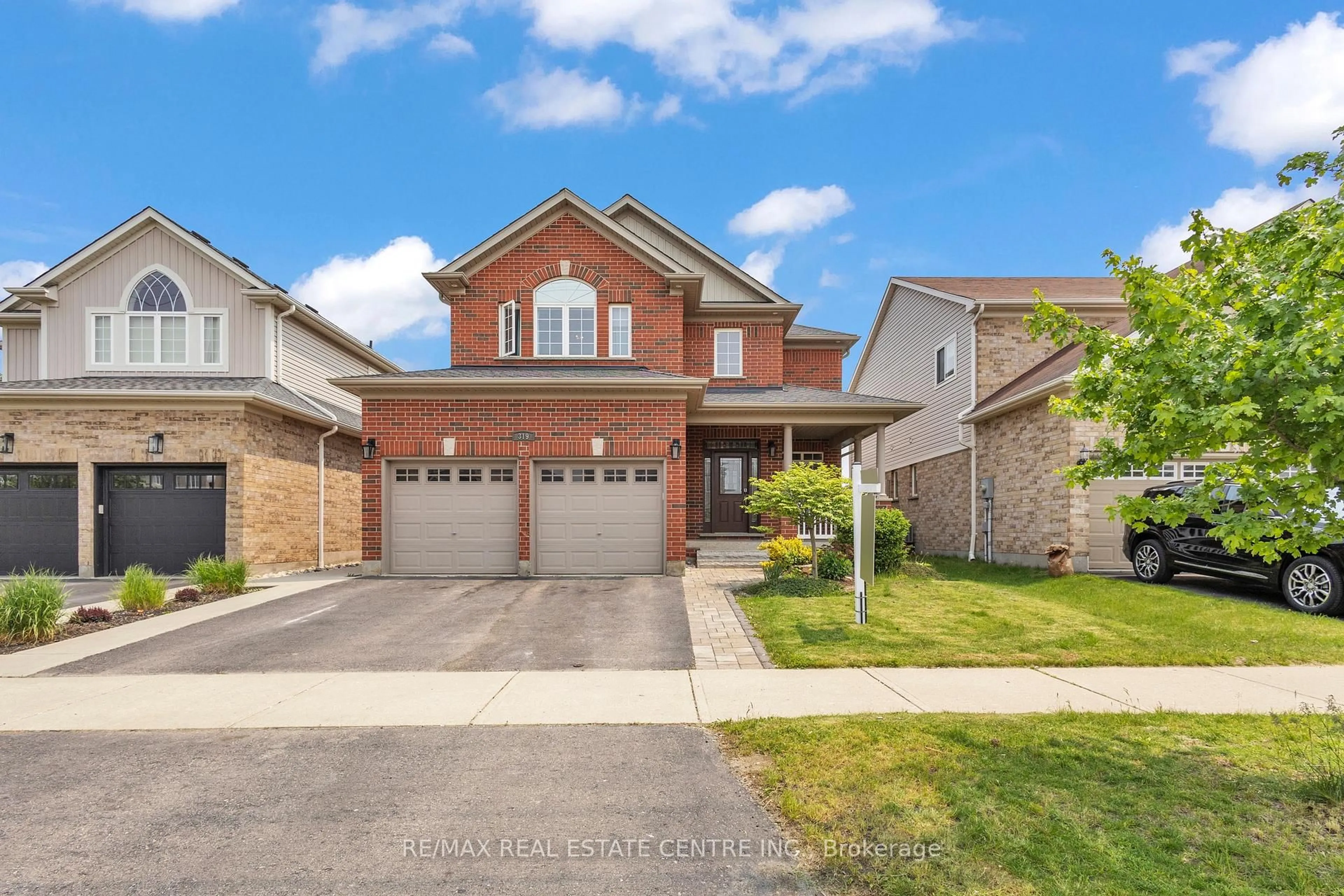 Home with brick exterior material, street for 319 Robert Ferrie Dr, Kitchener Ontario N2P 2Y7