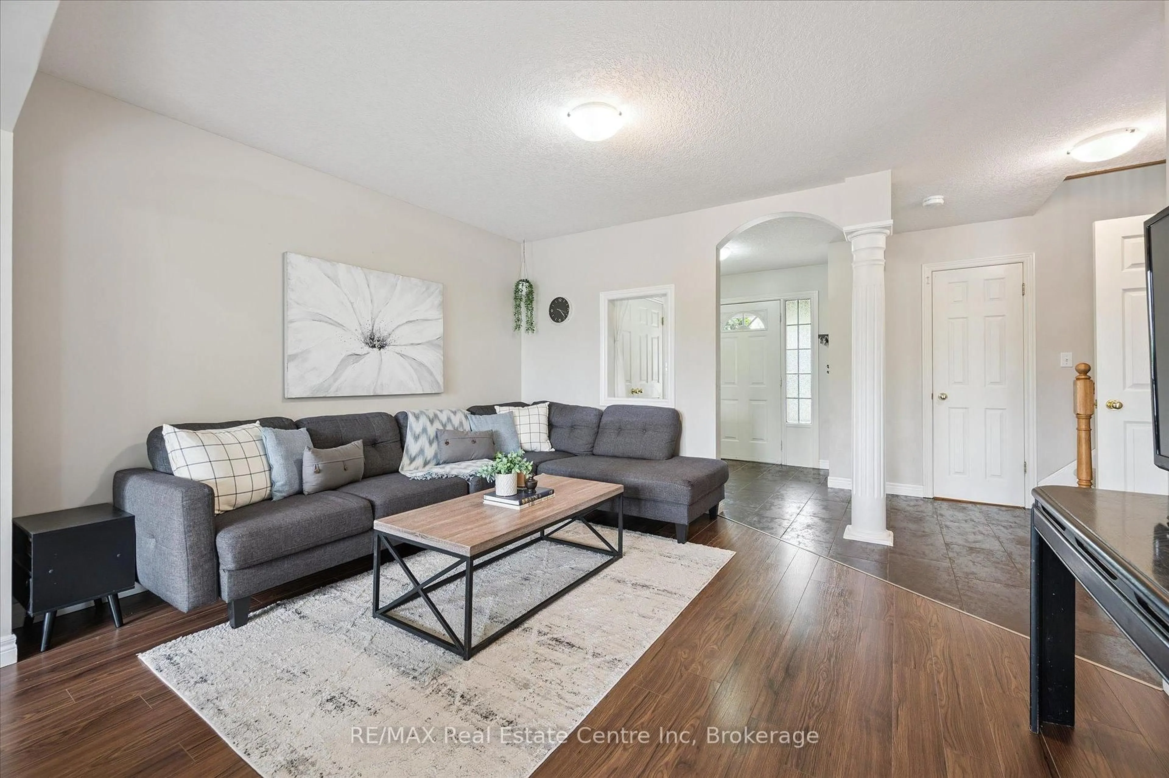 Living room with furniture, wood/laminate floor for 266 Briarmeadow Dr, Kitchener Ontario N2A 4H5