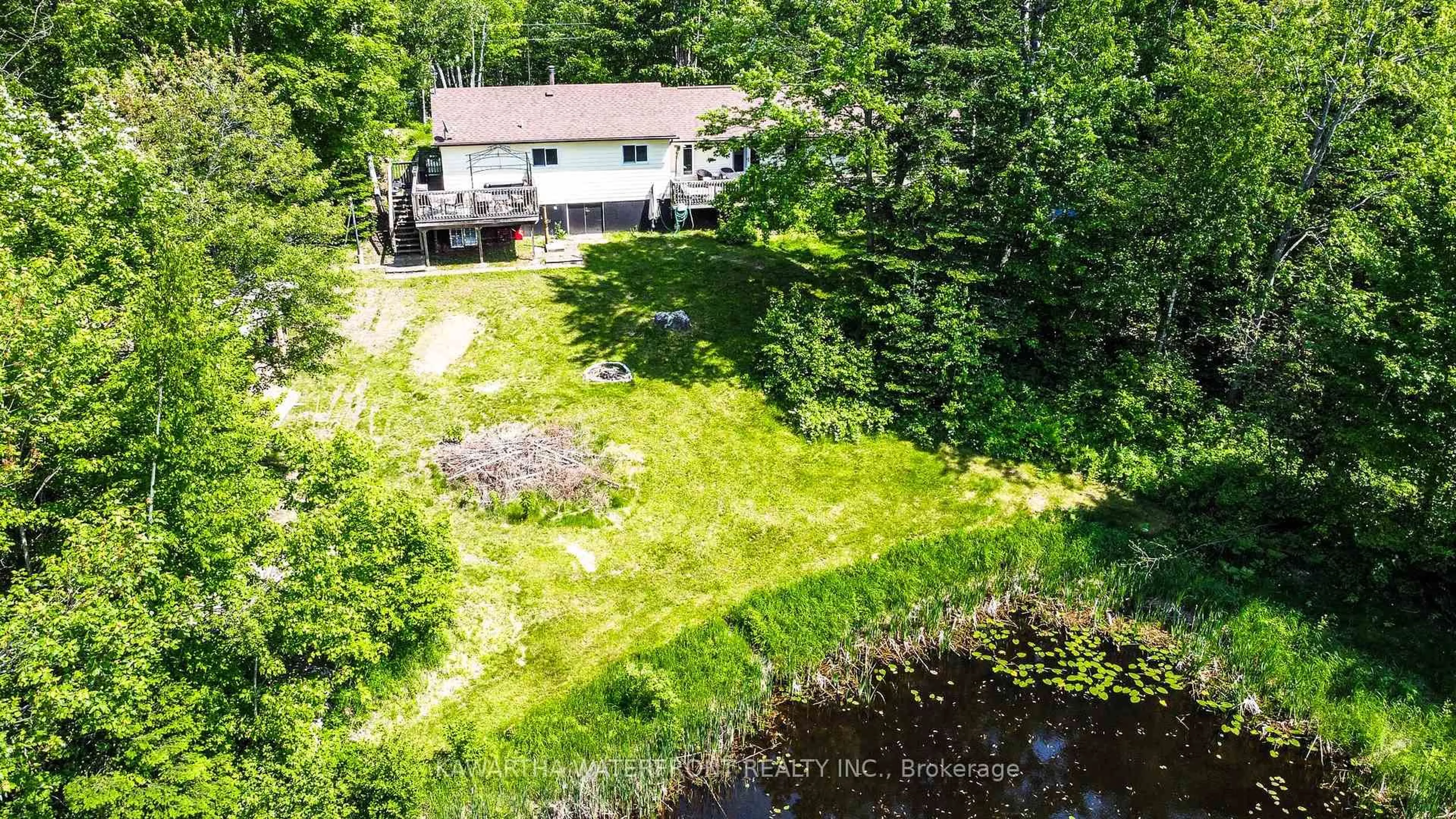 A pic from outside/outdoor area/front of a property/back of a property/a pic from drone, water/lake/river/ocean view for 1170 English Circ, Highlands East Ontario K0M 1R0