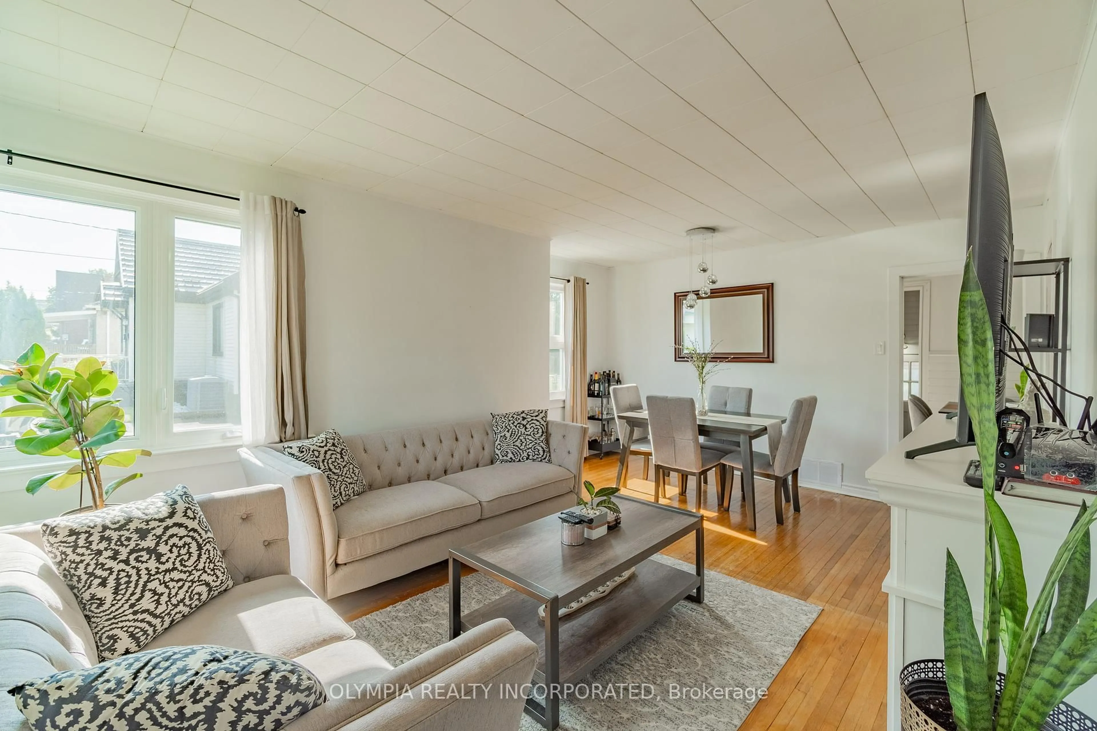 Living room with furniture, wood/laminate floor for 6129 Keith St, Niagara Falls Ontario L2J 1K1