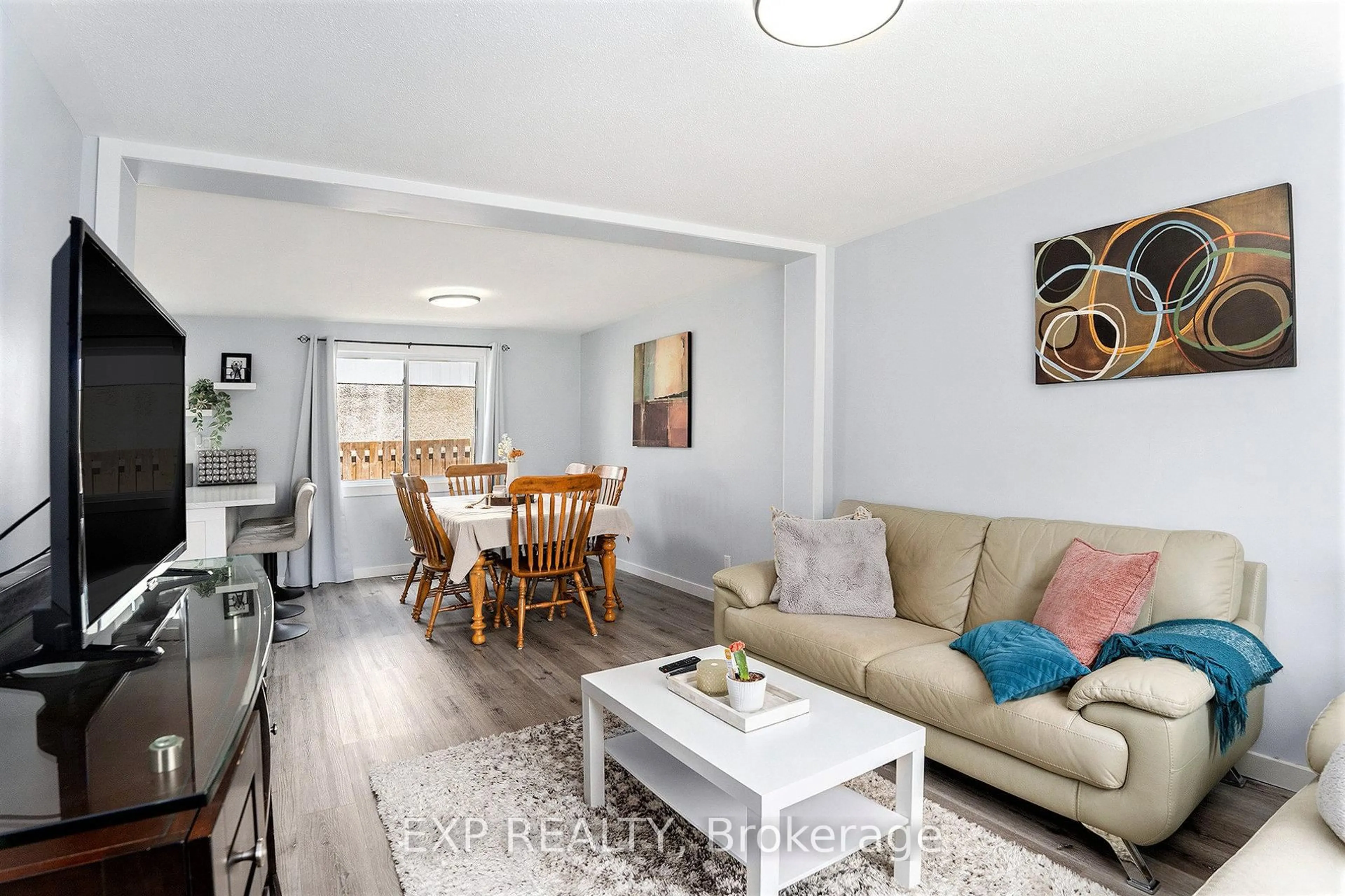 Living room with furniture, wood/laminate floor for 1520 Beaverpond Dr #D, Ottawa Ontario K1B 3R9
