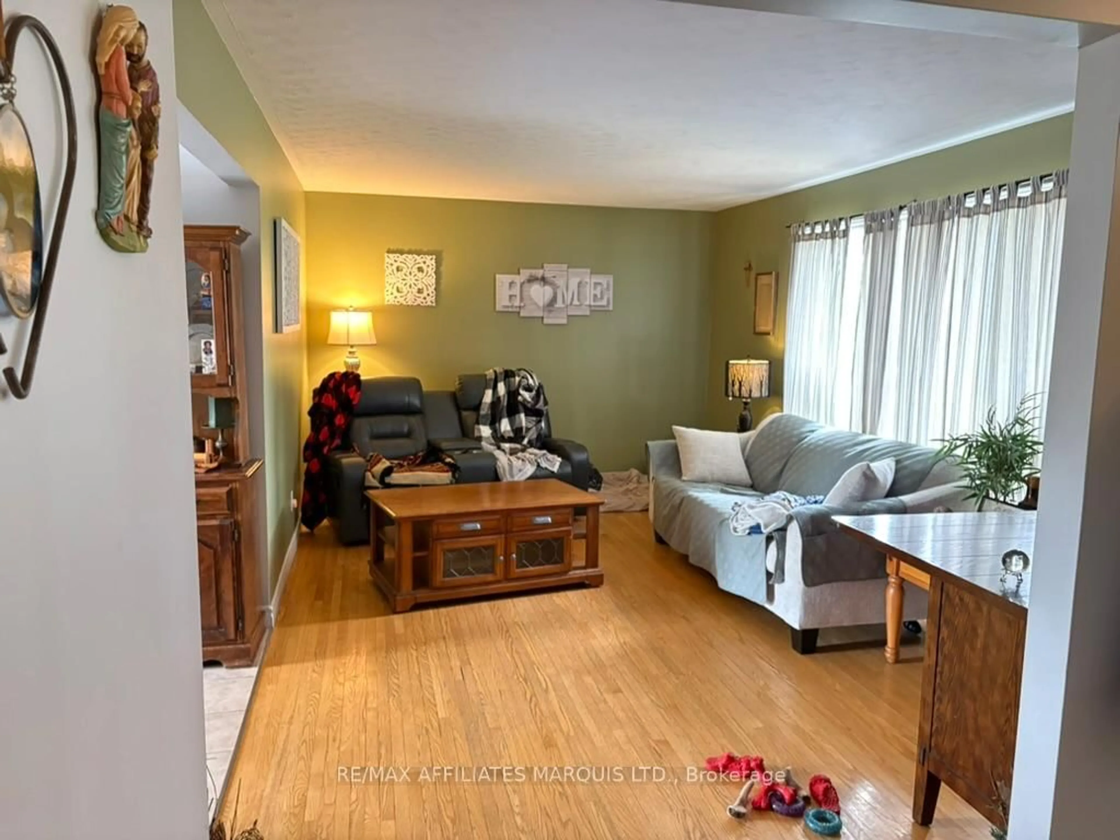 Living room with furniture, wood/laminate floor for 1209 Fatima St, Cornwall Ontario K6J 4Z7