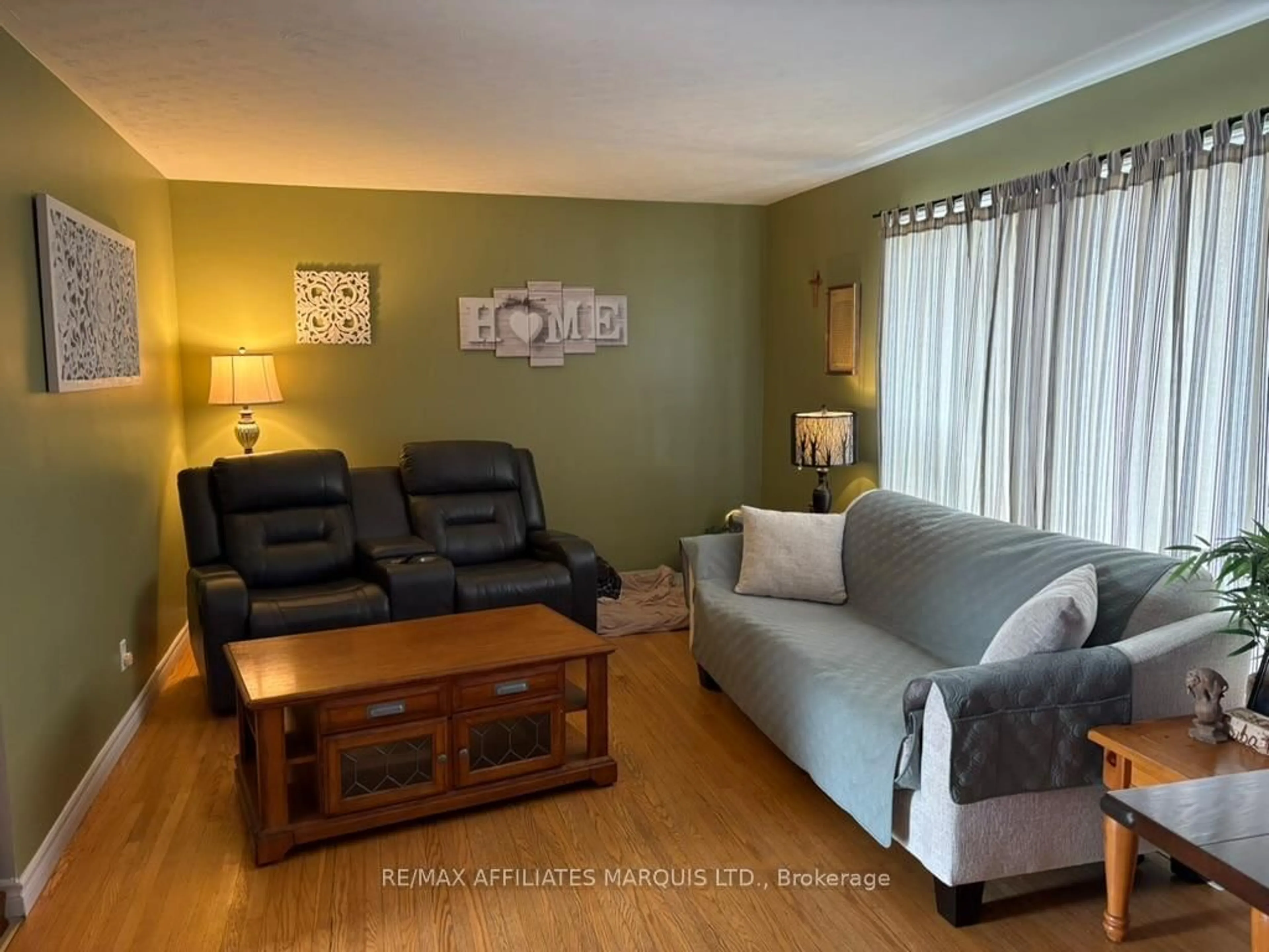 Living room with furniture, wood/laminate floor for 1209 Fatima St, Cornwall Ontario K6J 4Z7
