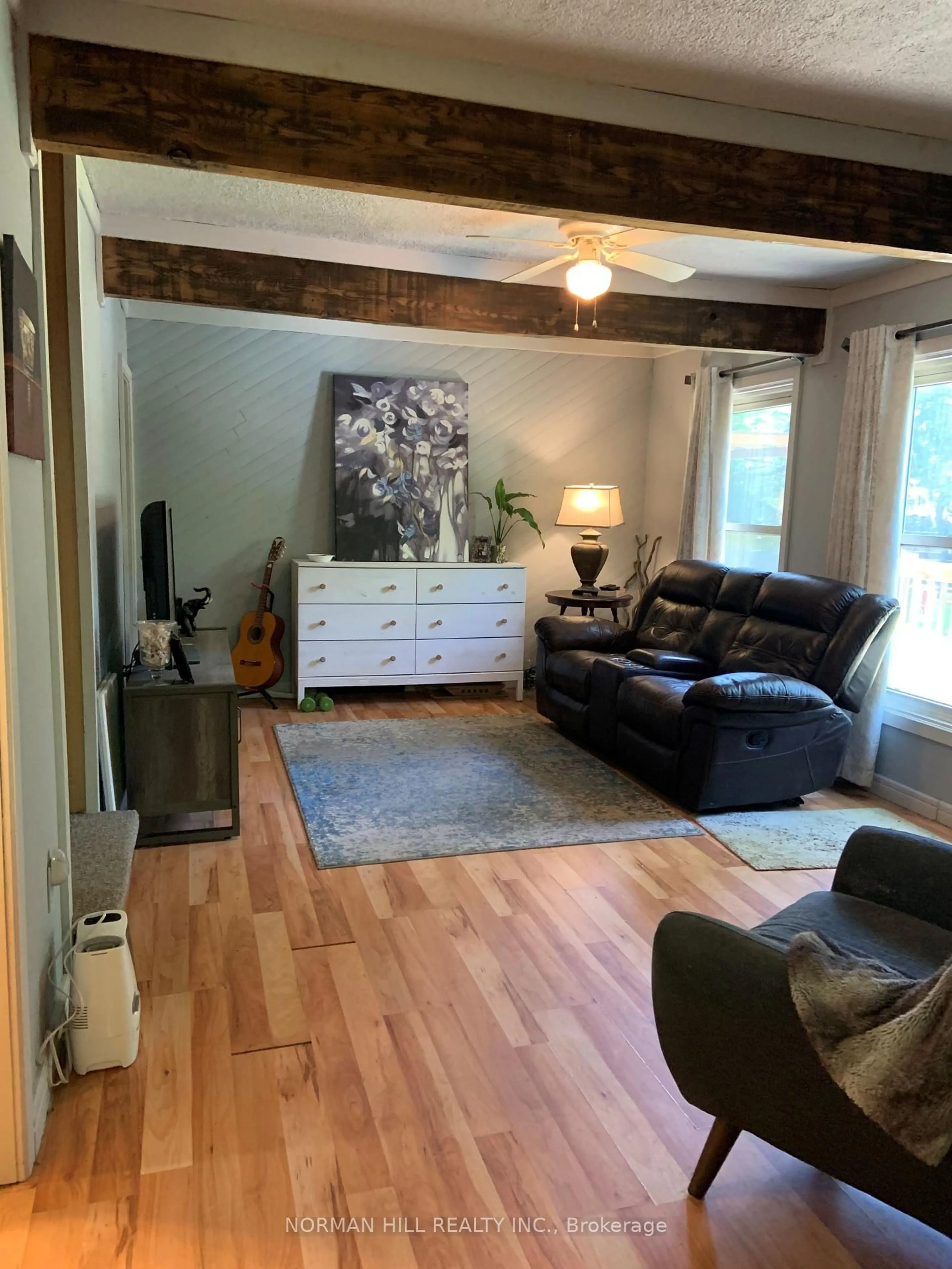 Living room with furniture, wood/laminate floor for 1094 Springdale Park Rd, Bracebridge Ontario P1L 1W9