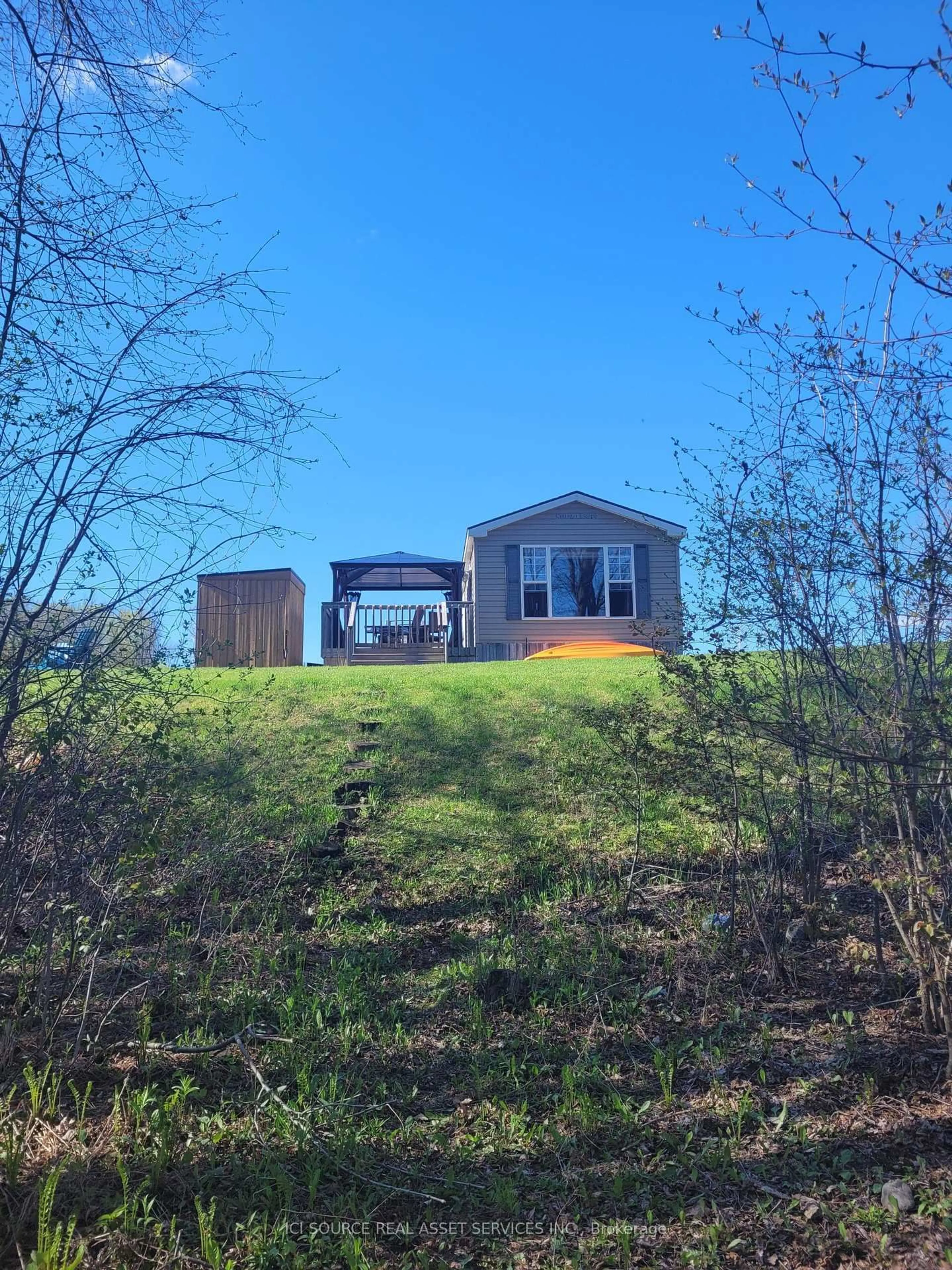 A pic from outside/outdoor area/front of a property/back of a property/a pic from drone, unknown for 1235 Villiers Line #GDFR025, Otonabee-South Monaghan Ontario K0L 2G0