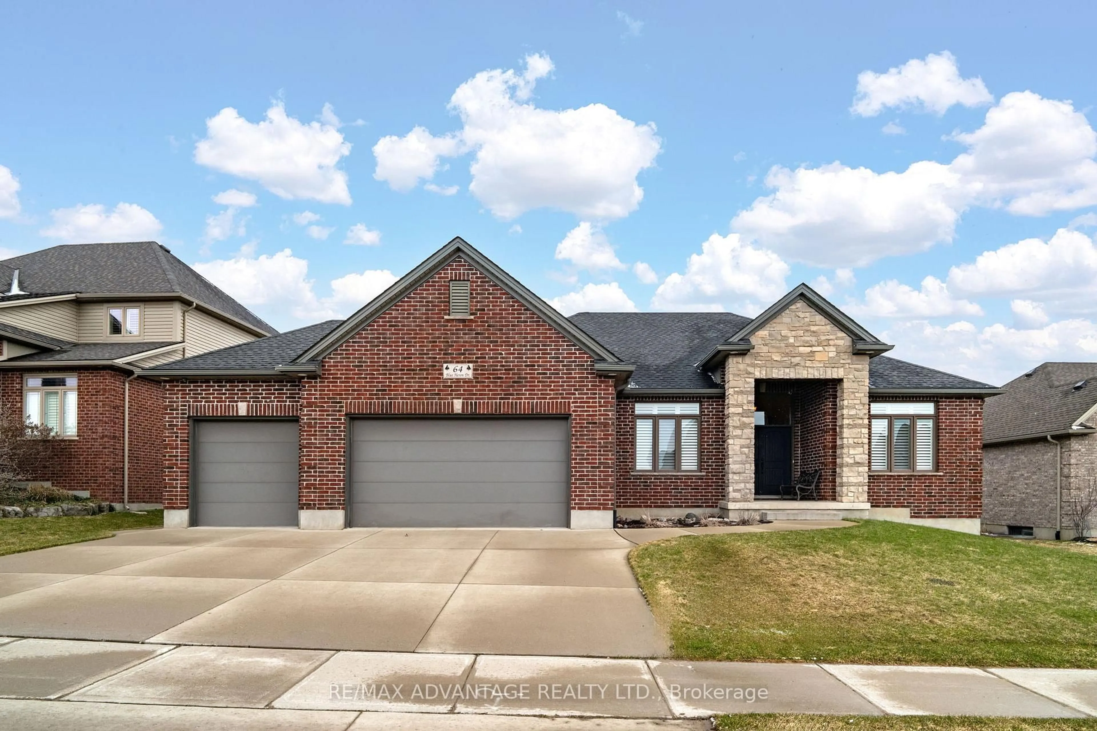 Home with brick exterior material, street for 64 Blue Heron Dr, Middlesex Centre Ontario N0M 2A0