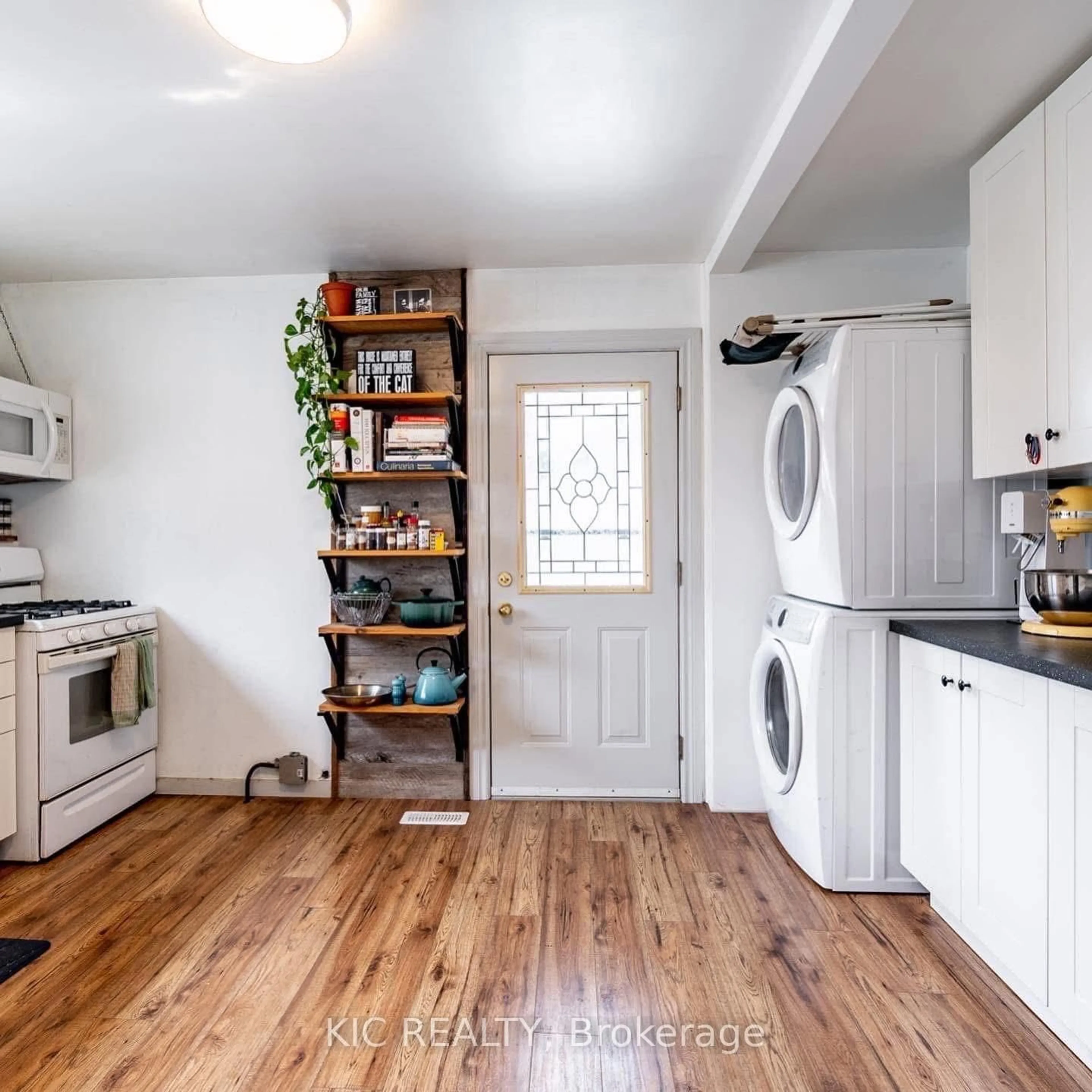Kitchen with laundary machines, wood/laminate floor for 196 Hunter St, Peterborough East Ontario K9H 1G8