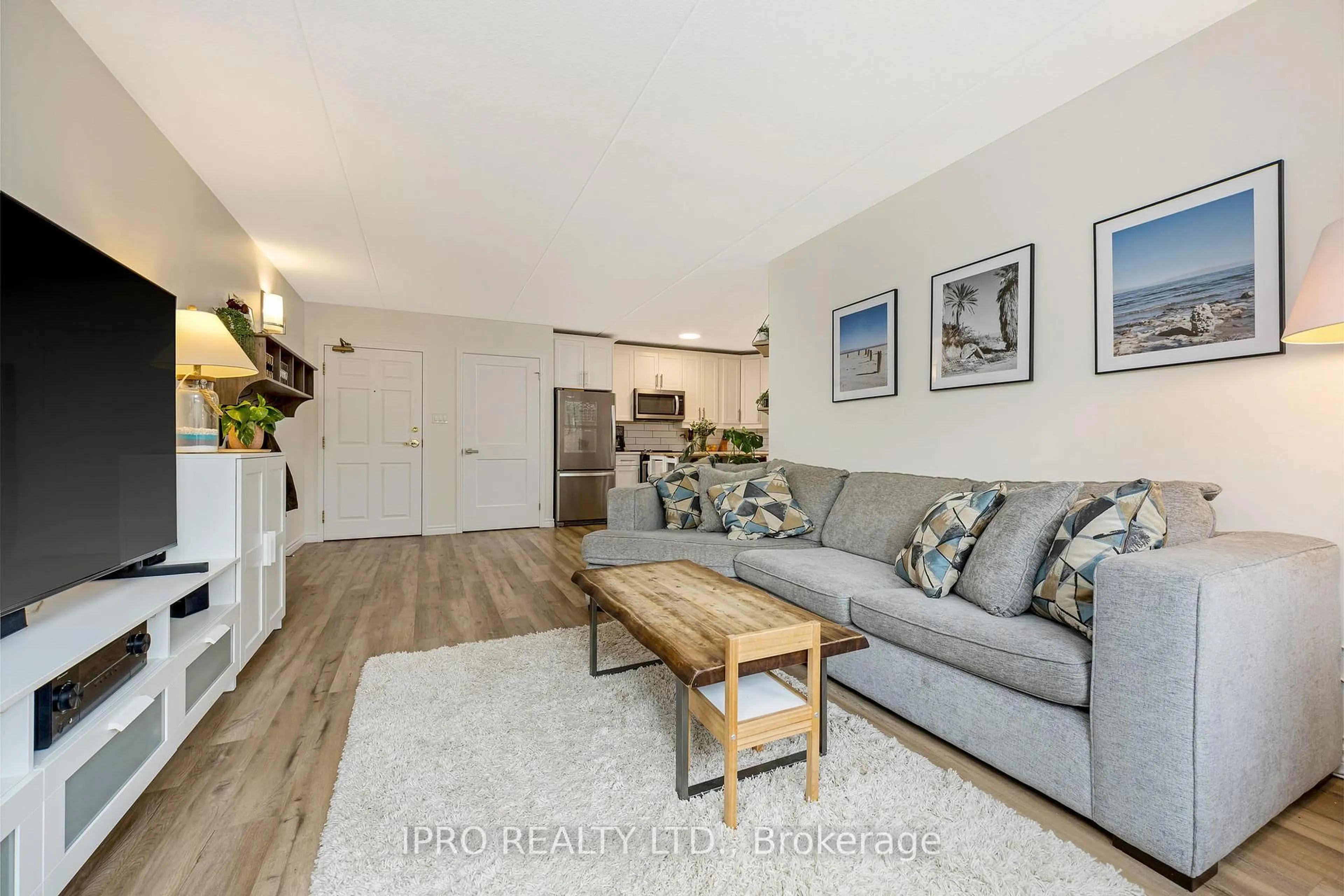 Living room with furniture, wood/laminate floor for 264 Alma St #203, Guelph/Eramosa Ontario N0B 2K0