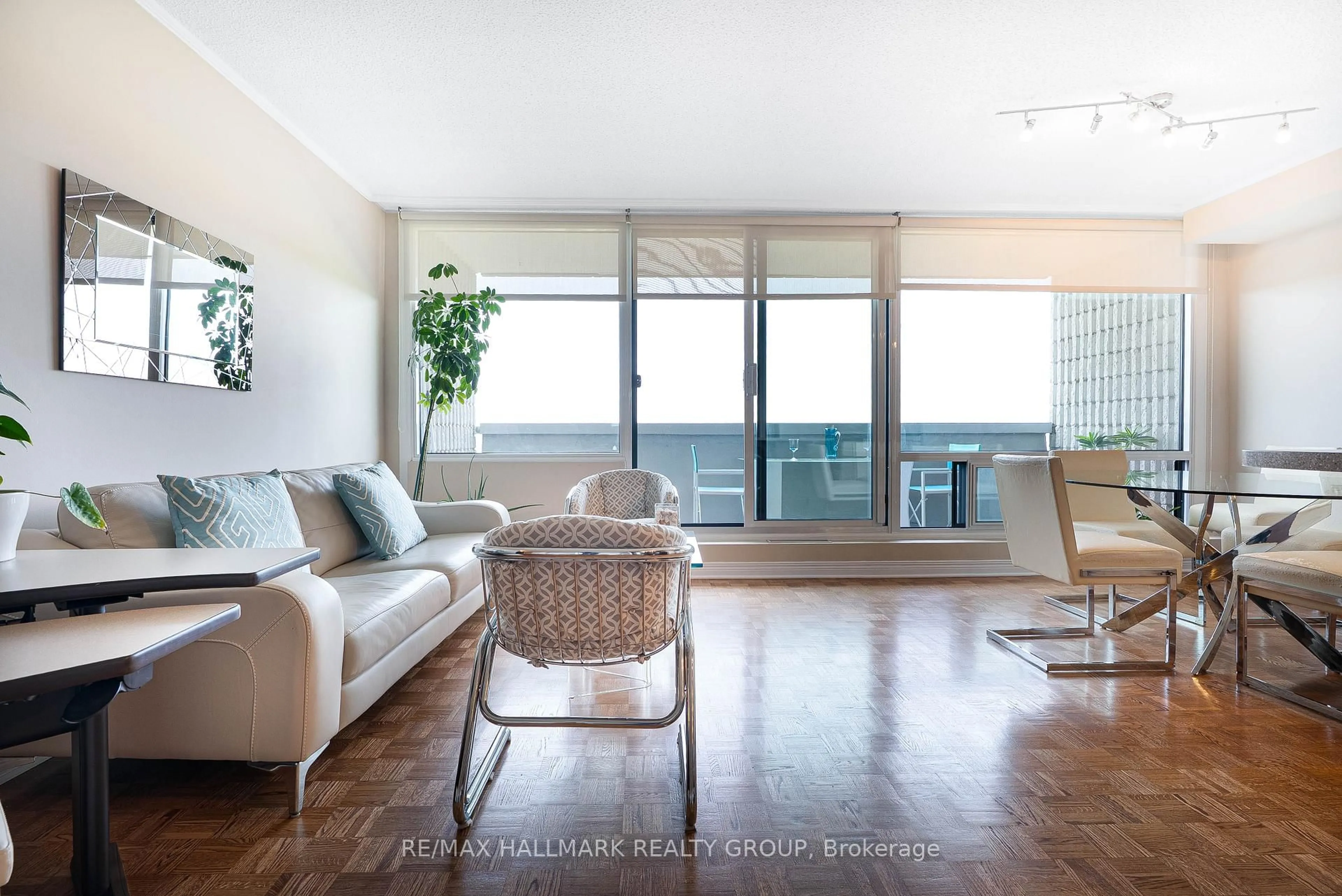 Living room with furniture, wood/laminate floor for 265 Poulin Ave #1011, Ottawa Ontario K2B 7Y8