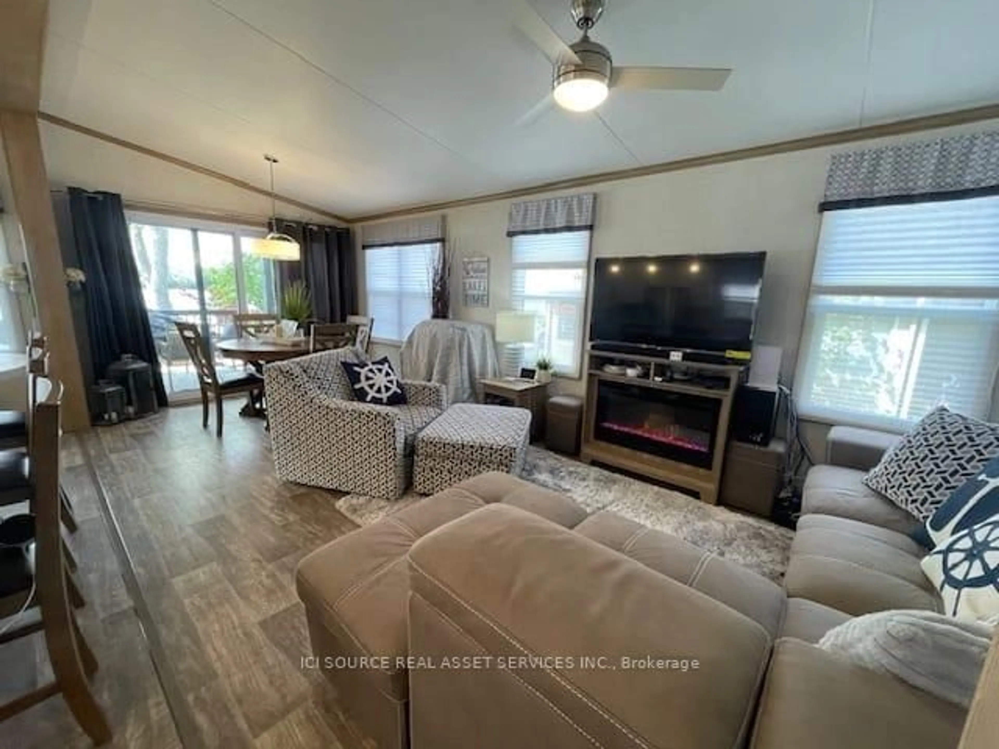 Living room with furniture, wood/laminate floor for 486 County Rd 18 #CBL087, Prince Edward County Ontario K0K 1P0